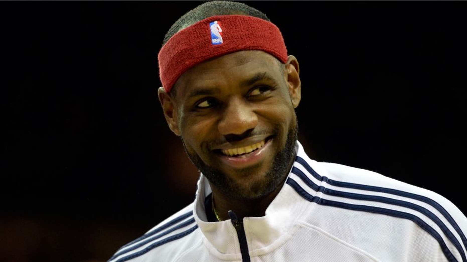 Oct 14, 2014; Cleveland, OH, USA; Cleveland Cavaliers forward LeBron James (23) smiles during a timeout in the fourth quarter against the Milwaukee Bucks at Quicken Loans Arena. Mandatory Credit: David Richard-USA TODAY Sports