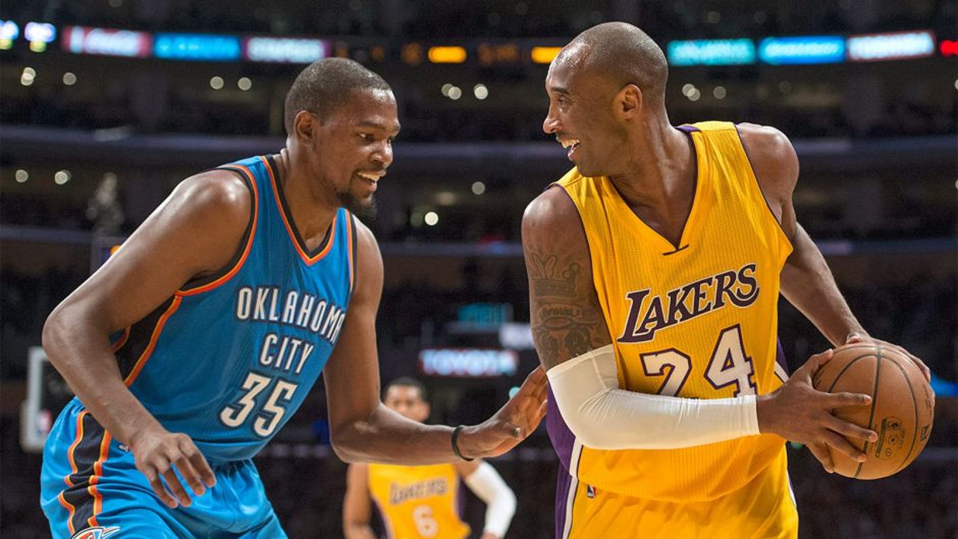 Los Angeles Lakers' Kobe Bryant, right, smiles with Oklahoma City Thunder's Kevin Durant during an NBA basketball game Wednesday, Dec. 23, 2015, in Los Angeles. (Kyusung Gong/The Orange County Register via AP)