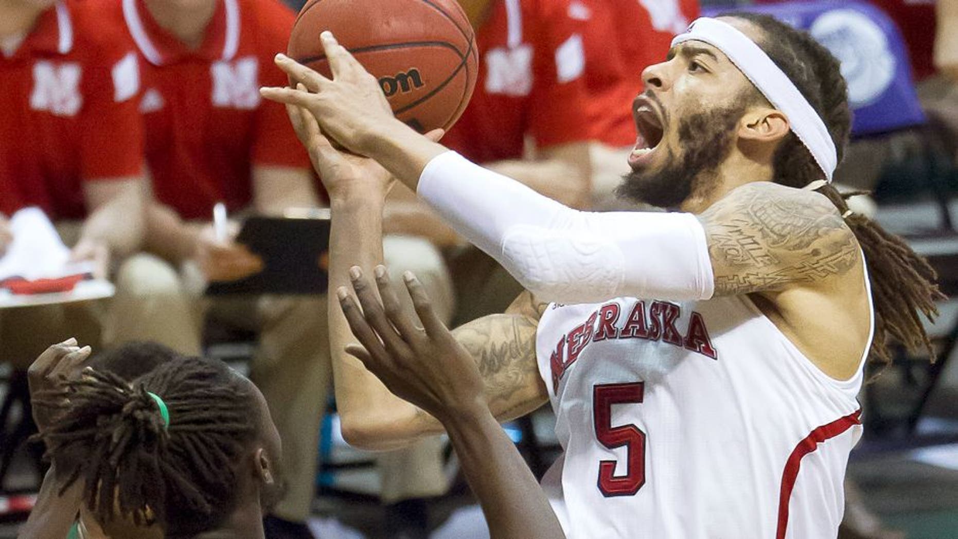 Nebraska forward Terran Petteway (5) drives down the lane with the basketball while defended by Ohio forward Maurice Ndour (5) in the second half of an NCAA college basketball game at the Diamond Head Classic on Thursday, Dec. 25, 2014, in Honolulu. Nebraska defeated Ohio 71-58. (AP Photo/Eugene Tanner)