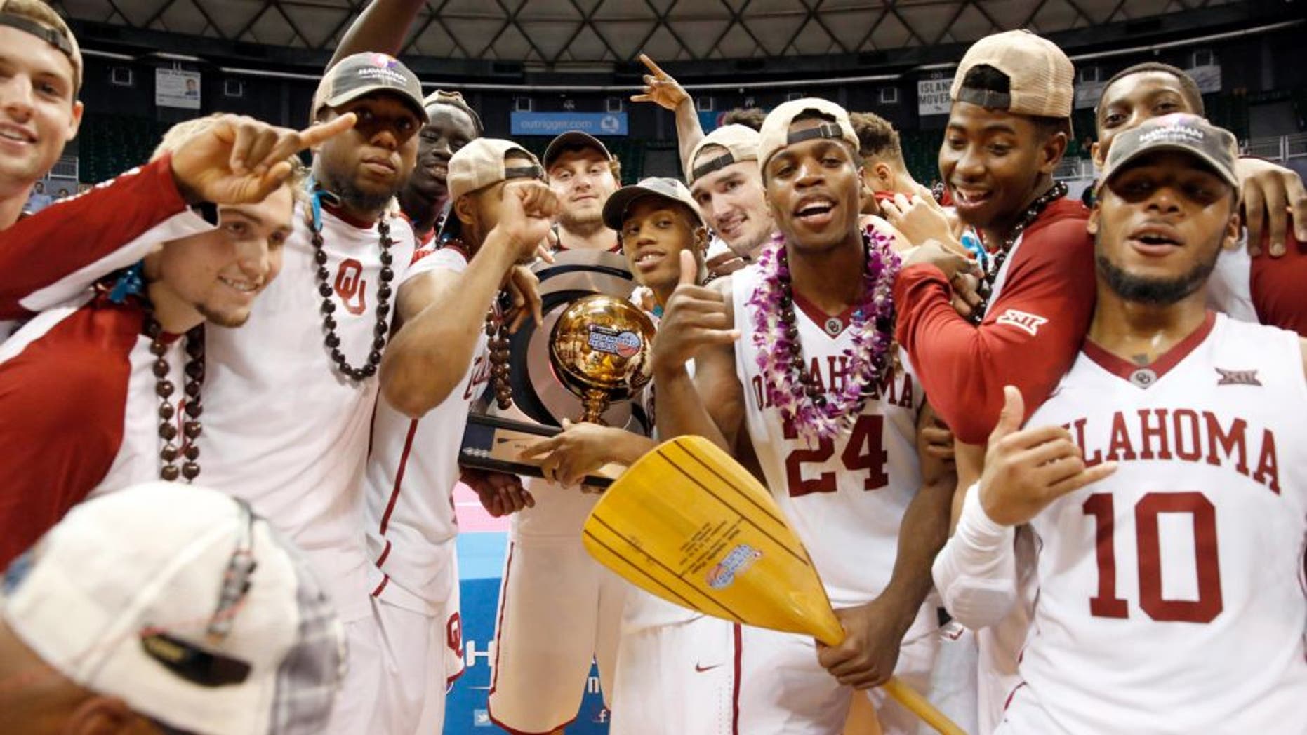 Dec 25, 2015; Honolulu, HI, USA; The Oklahoma Sooners celebrate after defeating the Harvard Crimson at the Stan Sheriff Center. Oklahoma Sooners defeated the Harvard Crimson 83-71. Mandatory Credit: Marco Garcia-USA TODAY Sports
