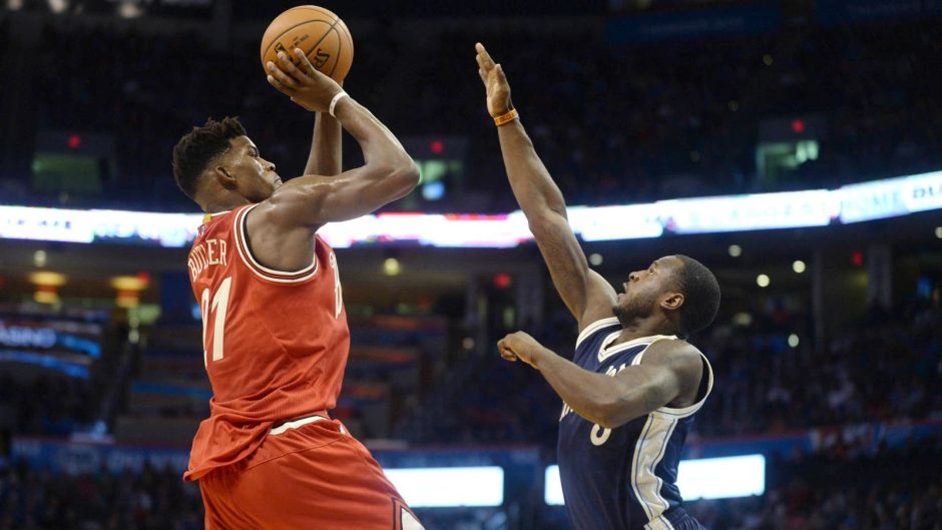 Dec 25, 2015; Oklahoma City, OK, USA; Chicago Bulls guard Jimmy Butler (21) shoots the ball against Oklahoma City Thunder guard Dion Waiters (3) during the second half of a NBA basketball game on Christmas at Chesapeake Energy Arena. Mandatory Credit: Mark D. Smith-USA TODAY Sports