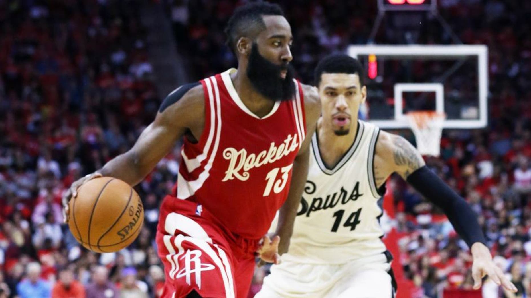 HOUSTON, TX - DECEMBER 25: James Harden #13 of the Houston Rockets drives with the basketball against Danny Green #14 of the San Antonio Spurs during their game at the Toyota Center on December 25, 2015 in Houston, Texas. NOTE TO USER: User expressly acknowledges and agrees that, by downloading and or using this Photograph, user is consenting to the terms and conditions of the Getty Images License Agreement. (Photo by Scott Halleran/Getty Images)
