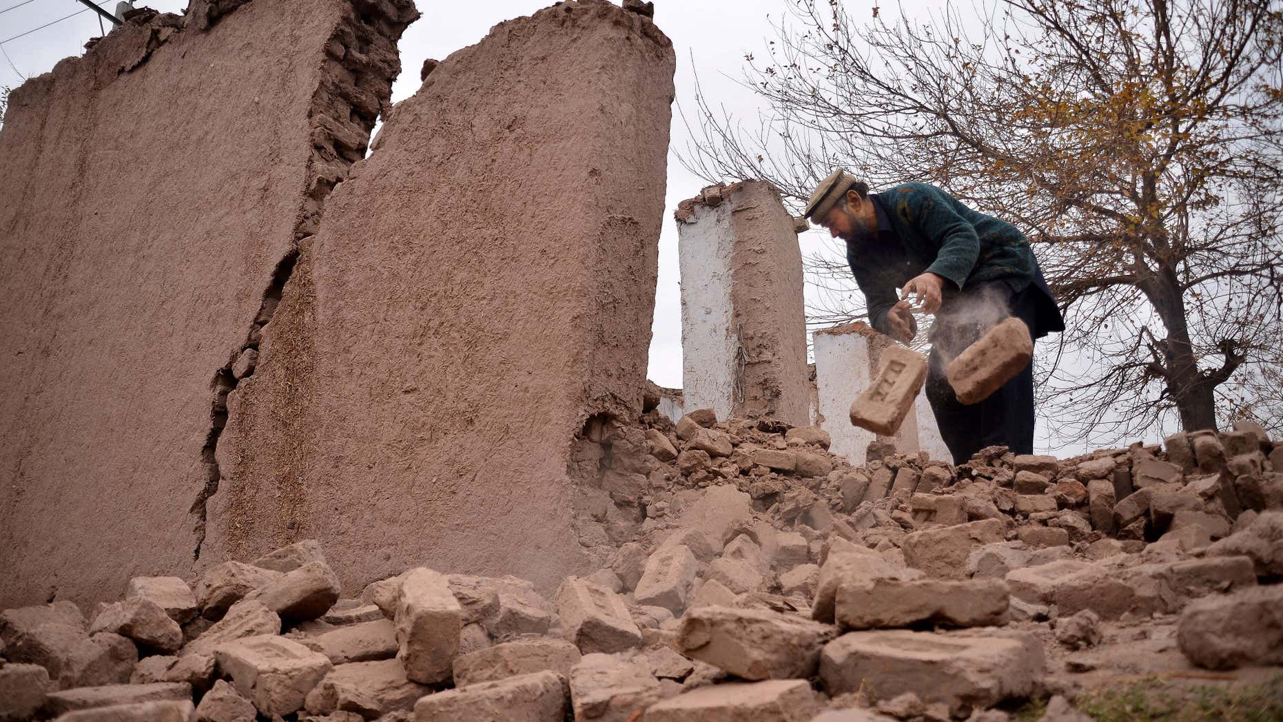 Dec. 26, 2015: An Afghan villager removes bricks after his home was damaged from an earthquake in Surkhroad district of Jalalabad east of Kabul, Afghanistan.