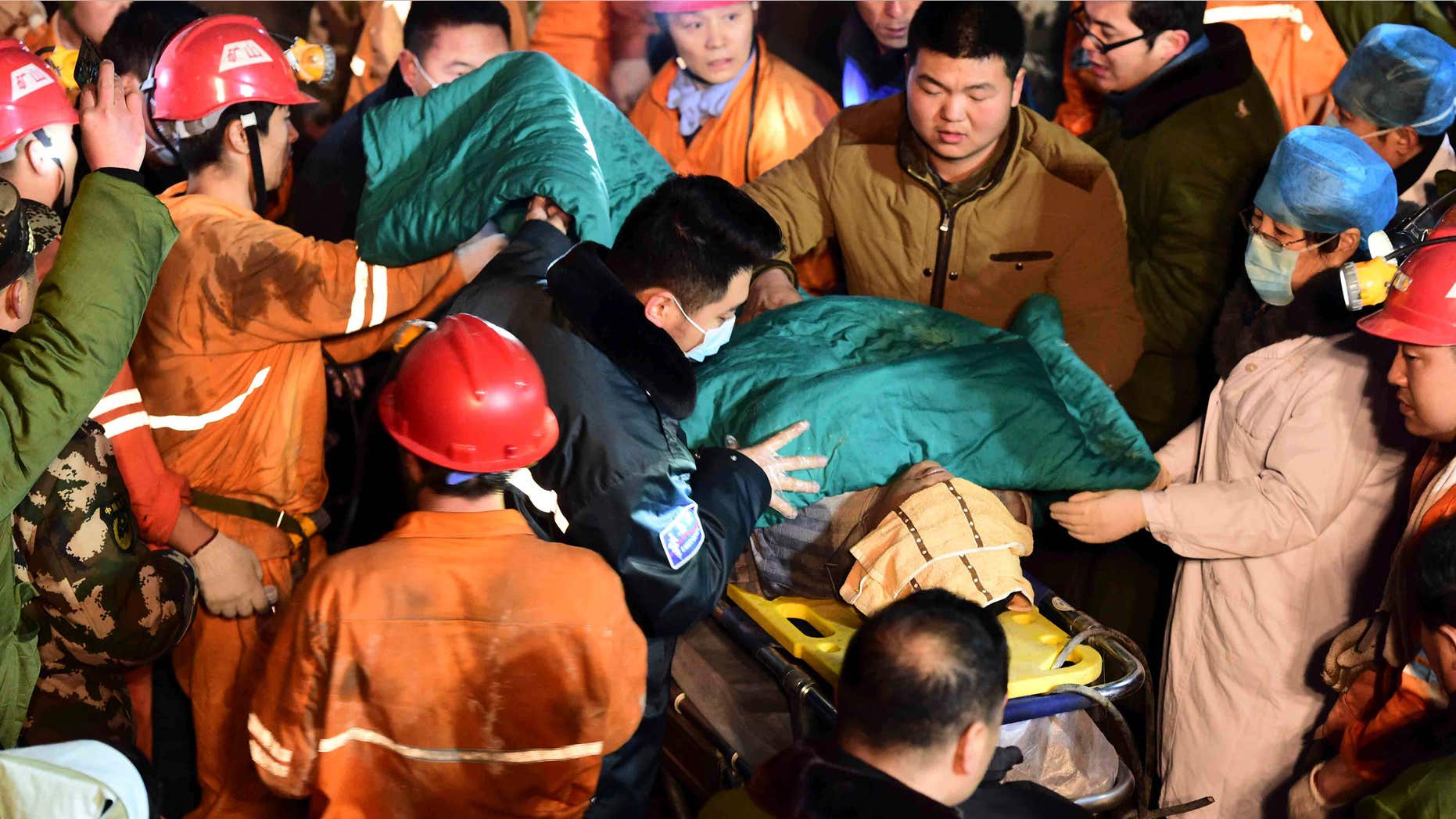 In this Dec. 25, 2015 photo released by China's Xinhua News Agency, a trapped miner is rescued from a collapsed gypsum mine in Pingyi County, east China's Shandong Province.