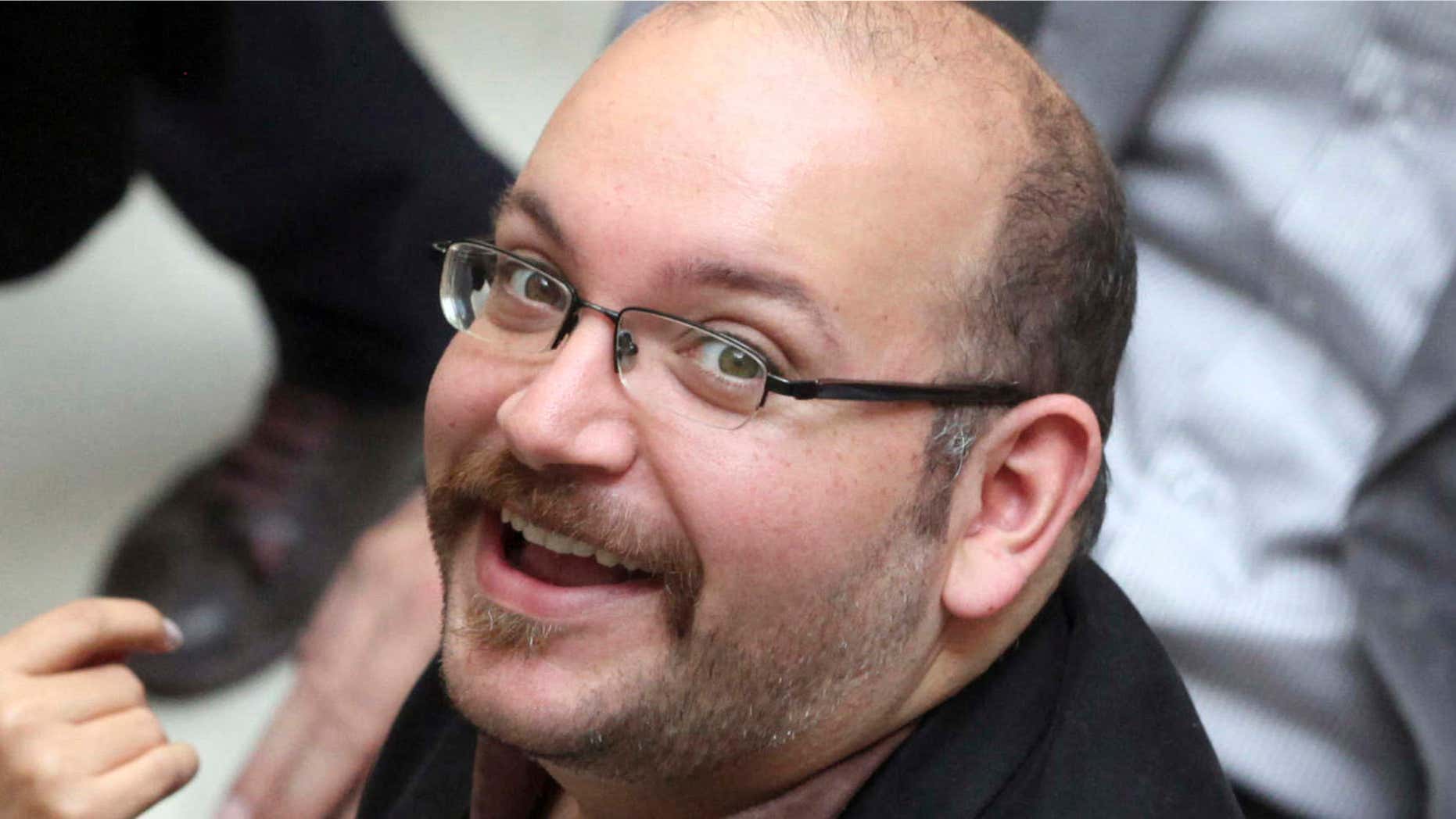 In this April 11, 2013 photo, Jason Rezaian, an Iranian-American correspondent for the Washington Post, smiles as he attends a presidential campaign of President Hassan Rouhani in Tehran, Iran.