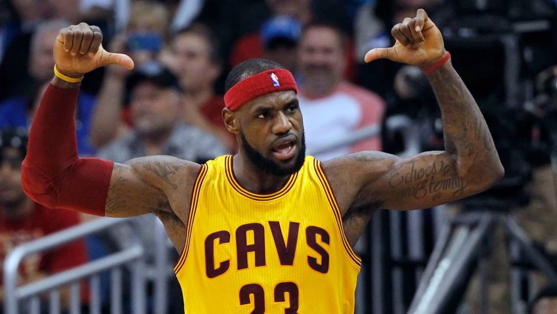 Dec 26, 2014; Orlando, FL, USA; Cleveland Cavaliers forward LeBron James (23) points to his back of his jersey after he made a shot during the fourth quarter against the Orlando Magic at Amway Center. Cleveland Cavaliers defeated the Orlando Magic 98-89. Mandatory Credit: Kim Klement-USA TODAY Sports