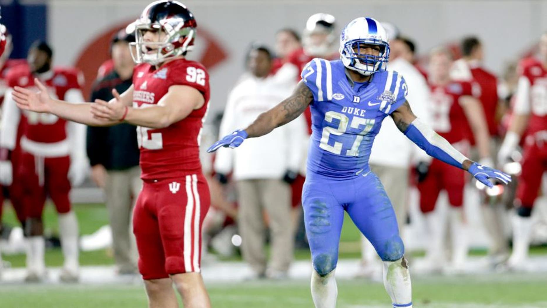 NEW YORK, NY - DECEMBER 26: DeVon Edwards #27 of the Duke Blue Devils celebrates as Griffin Oakes #92 of the Indiana Hoosiers reacts to missing a field goal in overtime during the New Era Pinstripe Bowl at Yankee Stadium on December 26, 2015 in the Bronx borough of New York City. Duke defeated Indiana 44-41 in overtime. (Photo by Adam Hunger/Getty Images)