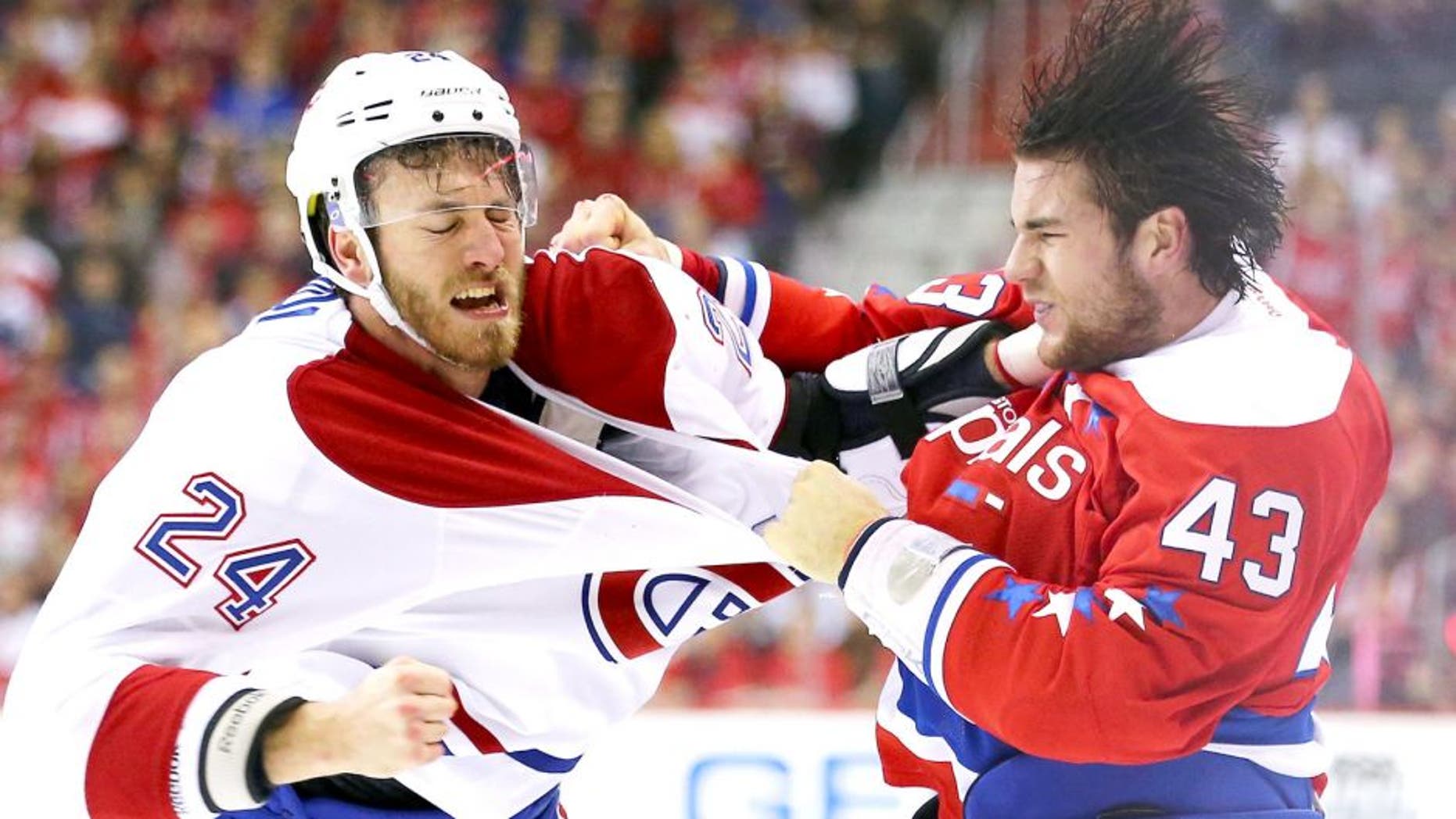 WASHINGTON, DC - DECEMBER 26: Jarred Tinordi #24 of the Montreal Canadiens and Tom Wilson #43 of the Washington Capitals exchange punches during the first period at Verizon Center on December 26, 2015 in Washington, DC. (Photo by Maddie Meyer/Getty Images)