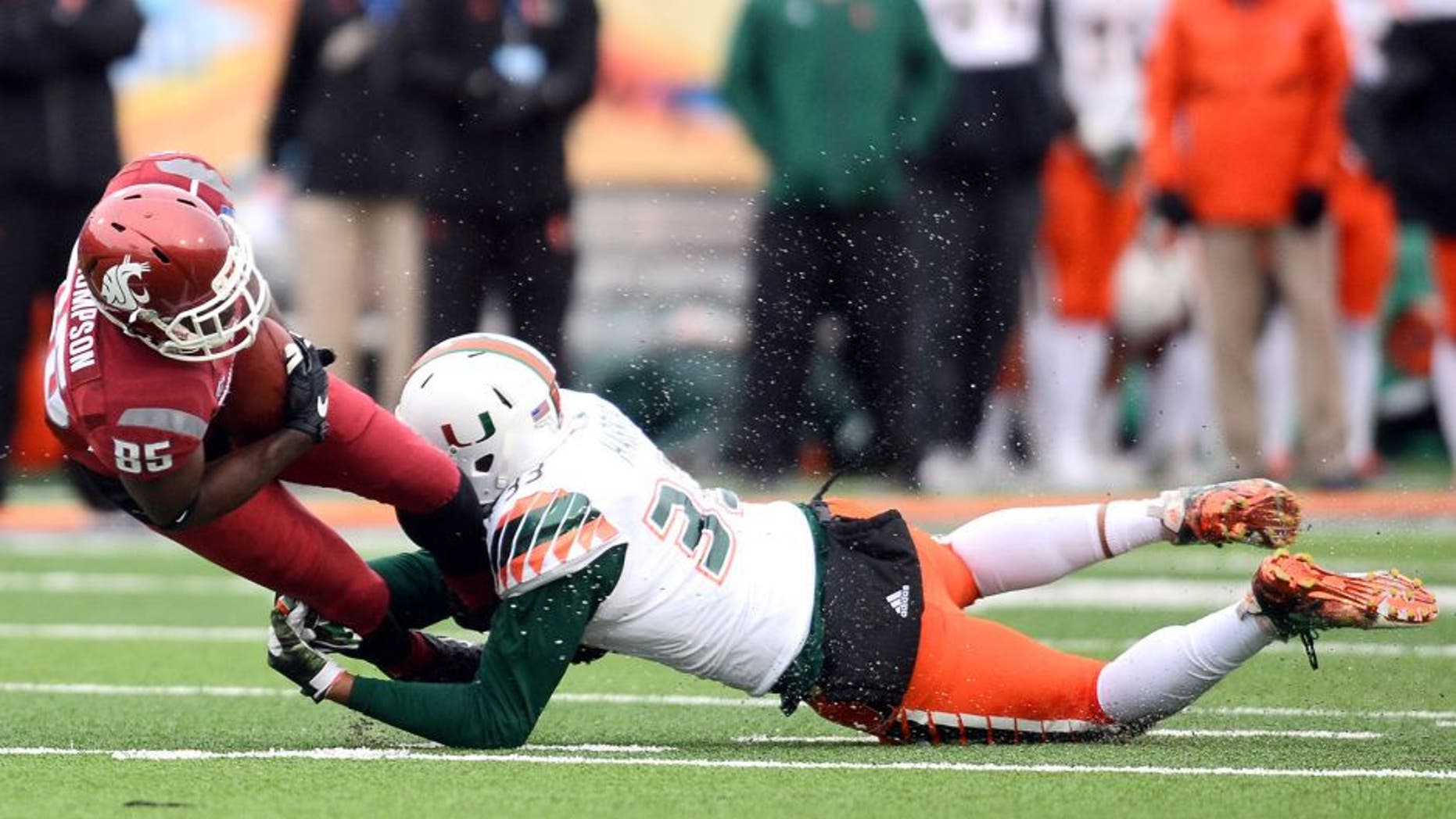 Dec 26, 2015; El Paso, TX, USA; Miami Hurricanes defensive lineman Trent Harris (33) tackles Washington State Cougars wide receiver John Thompson (85) during the second half at Sun Bowl Stadium. Mandatory Credit: Joe Camporeale-USA TODAY Sports