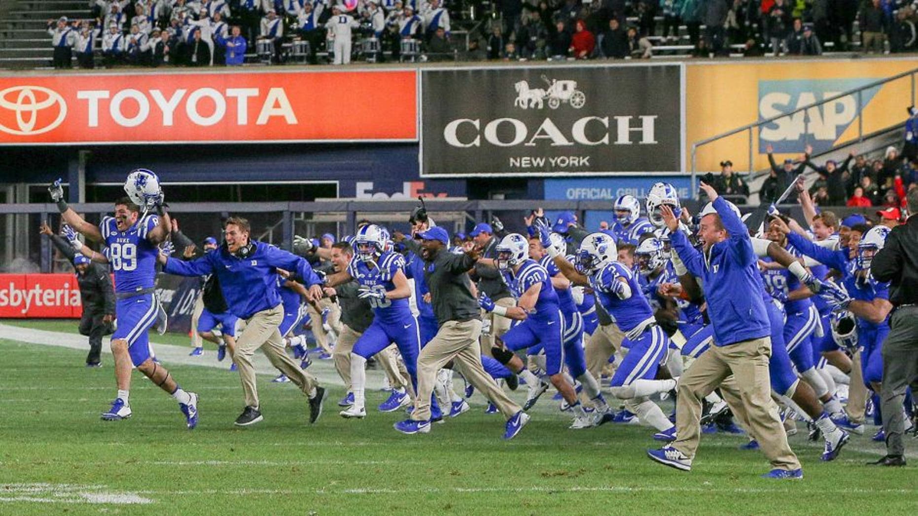 Dec 26, 2015; Bronx, NY, USA; The Duke Blue Devils players storms the field after the 2015 New Era Pinstripe Bowl against the Indiana Hoosiers at Yankee Stadium. The Blue Devils won 44-41 in overtime. Mandatory Credit: Vincent Carchietta-USA TODAY Sports