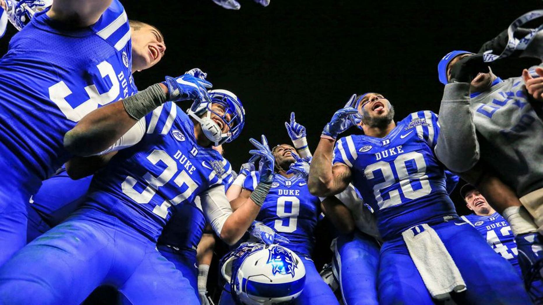 Dec 26, 2015; Bronx, NY, USA; The Duke Blue Devils players celebrate after their 2015 New Era Pinstripe Bowl against the Indiana Hoosiers at Yankee Stadium. The Blue Devils won 44-41 in overtime. Mandatory Credit: Vincent Carchietta-USA TODAY Sports