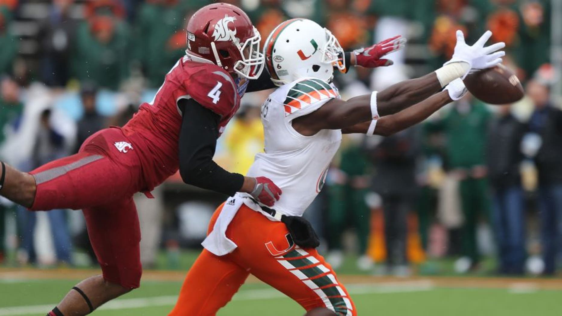 Miami receiver Herb Waters stretches to reach a long pass in front of Washington State defender Charleston White during the first half of the Sun Bowl NCAA college football game Saturday Dec. 26, 2015 in El Paso, Texas. (AP Photo/Victor Calzada)
