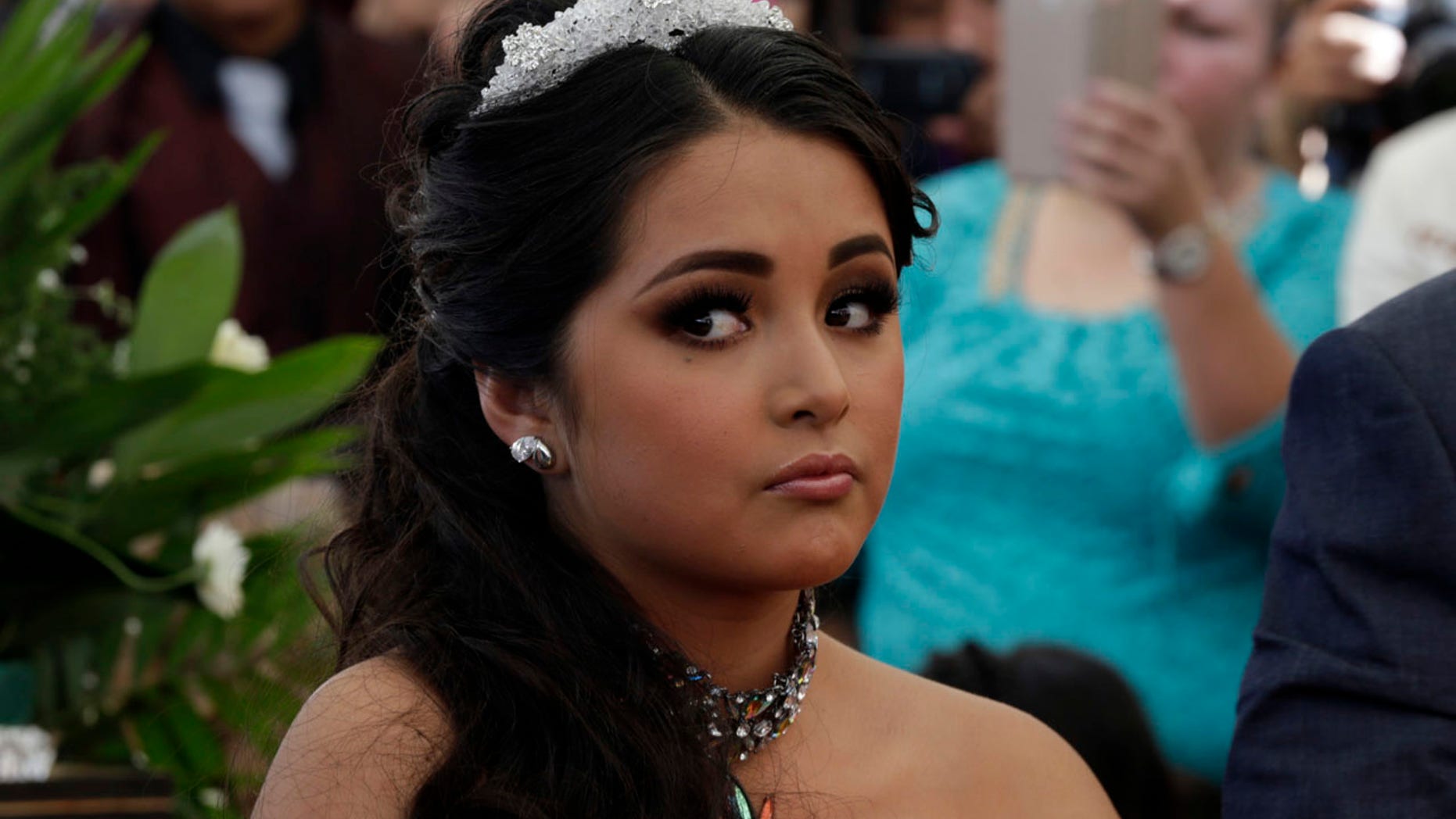 Dec. 26, 2016: Rubi Ibarra, in an elaborate fuchsia dress and gleaming tiara, sits for a Mass part of her down-home 15th birthday celebration in a field at her hometown of La Joya, San Luis Potosi State, Mexico.