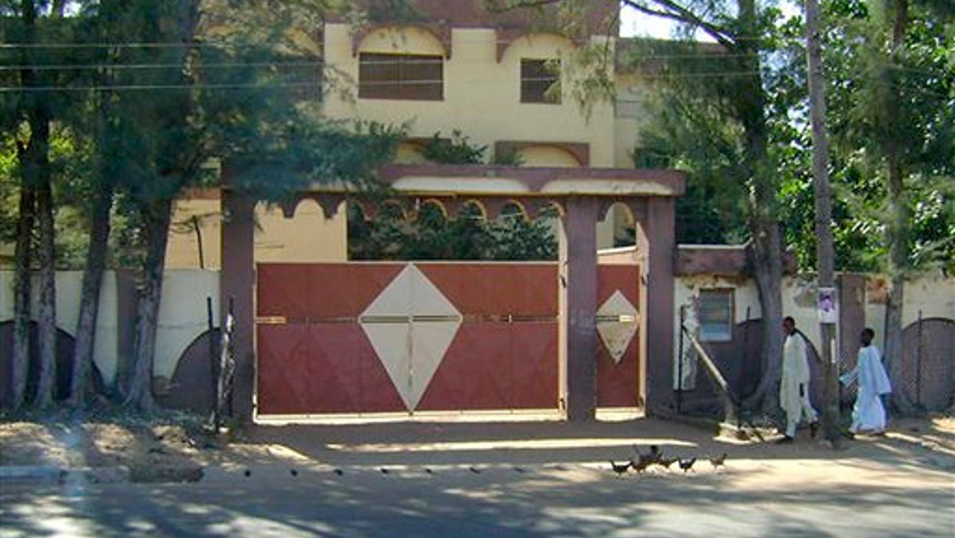 Sunday: Unidentified men walk in front of the house of Umaru Abdul Mutallab, the father of Umar Farouk Abdulmutallab, the alleged Christmas Day terrorist, in Funtua, Katsina state, Nigeria. The house serves as family residence but is only attended to when there is a wedding ceremony because the extended family lives either in Kaduna, Abuja, or overseas. (AP Photo)