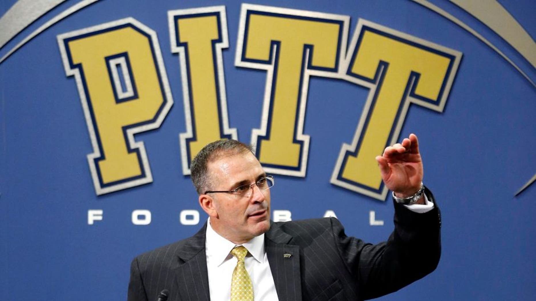Pat Narduzzi, the longtime Michigan State defensive coordinator, gestures as he speaks at an NCAA college news conference in Pittsburgh where he was introduced as the new head football coach for Pittsburgh, Friday, Dec. 26, 2014. Narduzzi replaces Paul Chryst who left Pitt last week after three seasons to become the coach at Wisconsin. (AP Photo/Keith Srakocic)