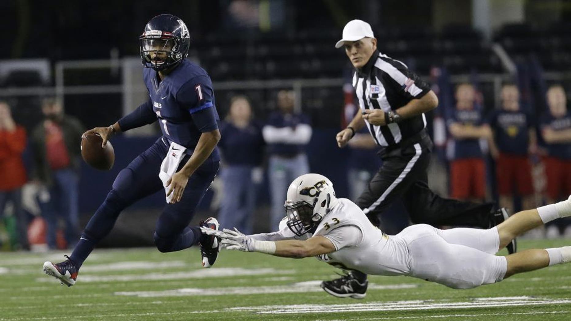 Allen quarterback Kyler Murray (1) eludes Cypress Ranch linebacker Brayden Stringer (33) during the first half of the UIL 6A Division I state championship football game Saturday, Dec. 20, 2014, in Arlington, Texas. (AP Photo/LM Otero)