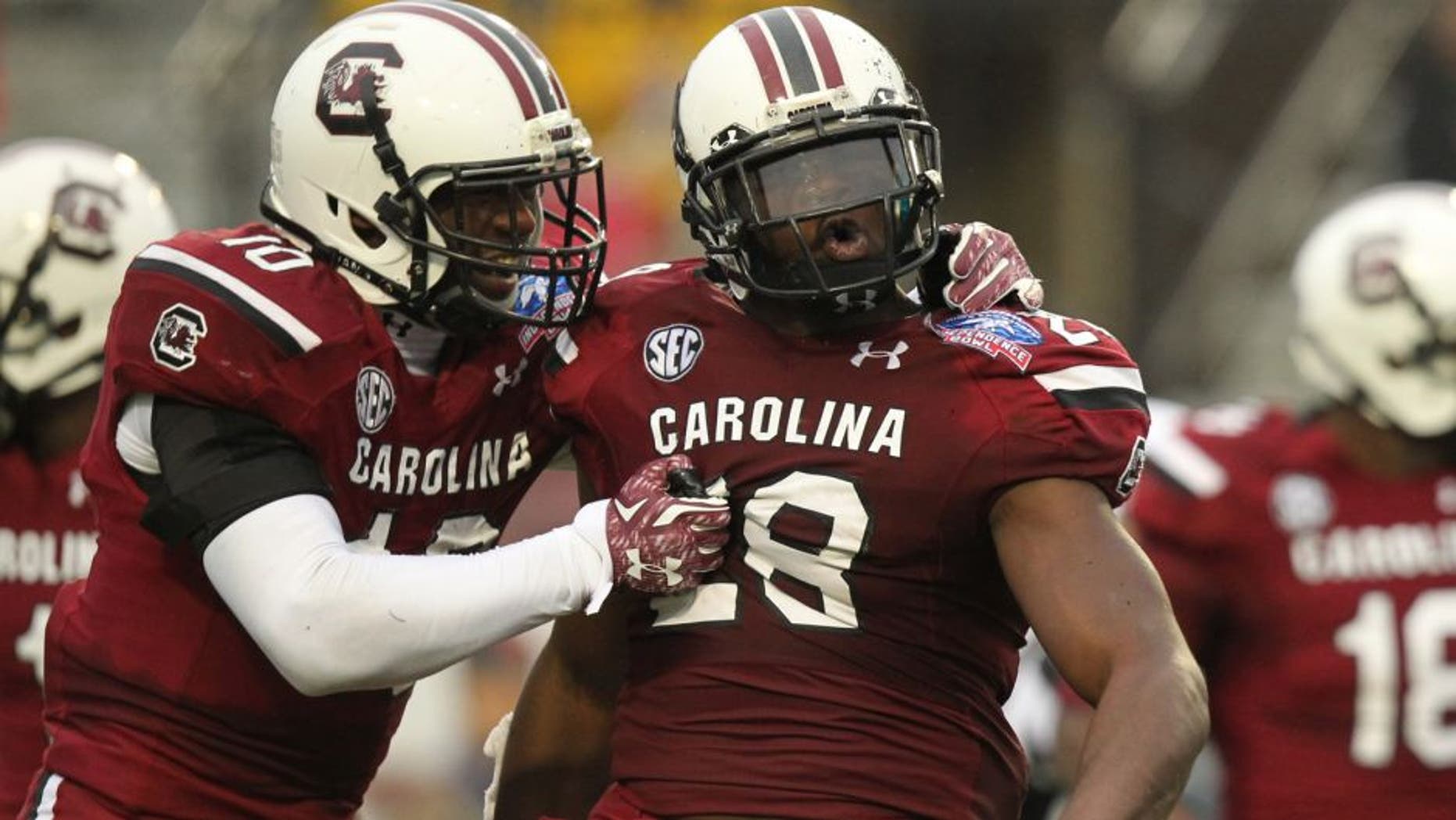 Dec 27, 2014; Shreveport, LA, USA; South Carolina Gamecocks linebacker Skai Moore (10) and linebacker Jonathan Walton (28) celebrate after an interception by Walton in the second quarter against the Miami Hurricanes in the 2014 Independence Bowl at Independence Stadium. Mandatory Credit: Nelson Chenault-USA TODAY Sports