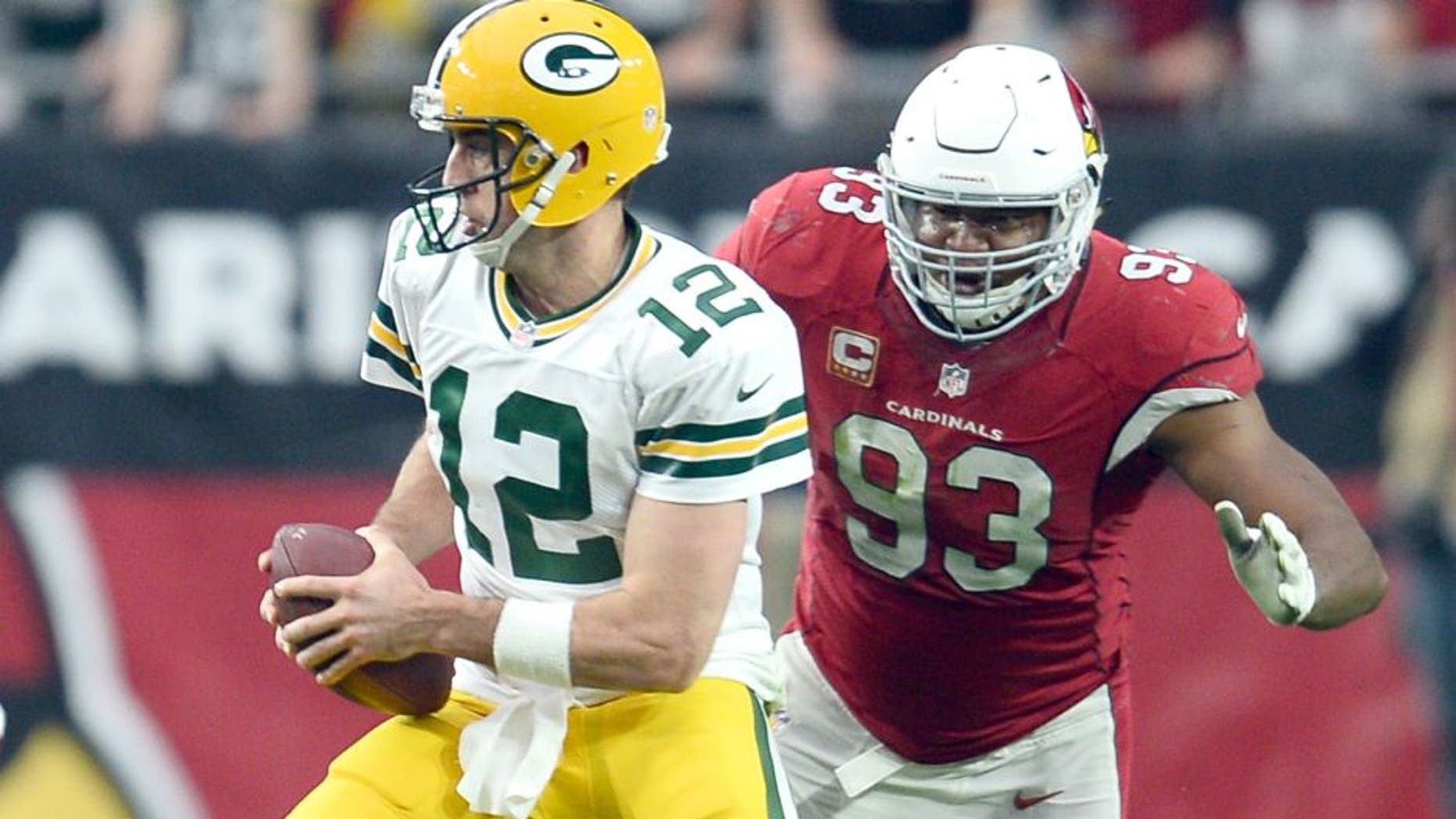 Dec 27, 2015; Glendale, AZ, USA; Arizona Cardinals defensive end Calais Campbell (93) pursues Green Bay Packers quarterback Aaron Rodgers (12) during the first half at University of Phoenix Stadium. Mandatory Credit: Joe Camporeale-USA TODAY Sports