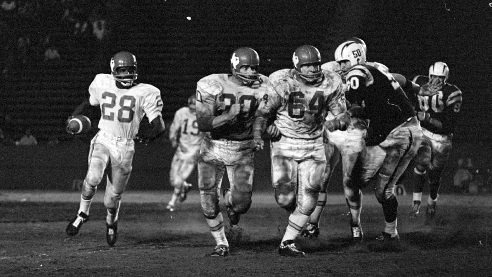 UNITED STATES - SEPTEMBER 12: Los Angeles Chargers vs. Dallas Texans. Texans Running back Abner Haynes runs the ball as teammates block out front for him. (Photo by Bob D'Olivo/The Enthusiast Network/Getty Images)