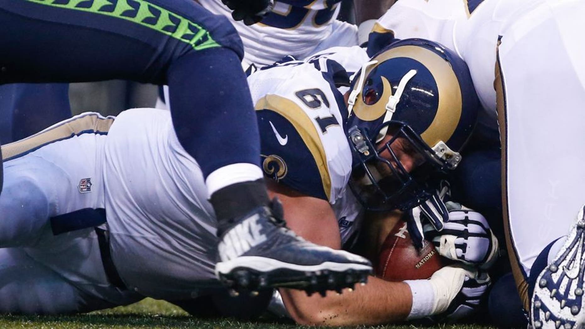 Dec 27, 2015; Seattle, WA, USA; St. Louis Rams center Tim Barnes (61) recovers a fumble against the Seattle Seahawks during the fourth quarter at CenturyLink Field. Mandatory Credit: Joe Nicholson-USA TODAY Sports