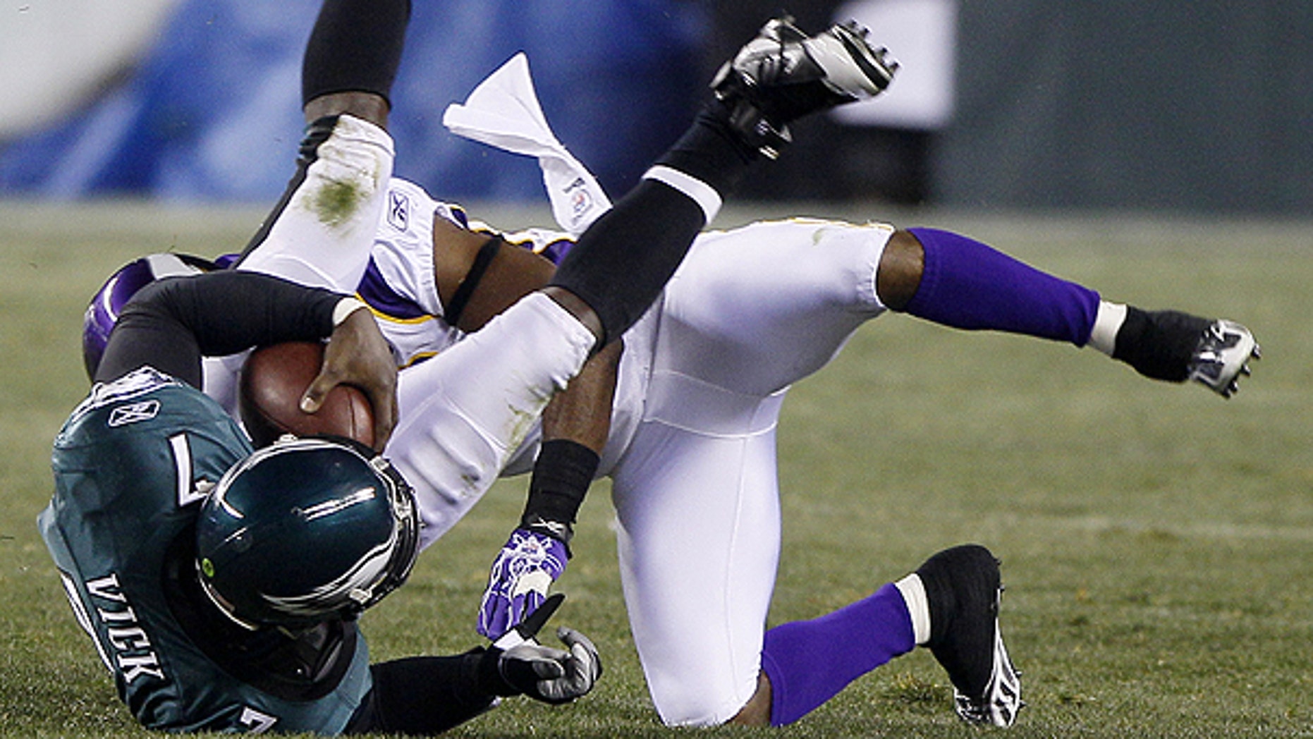 Dec. 28: Philadelphia Eagles quarterback Michael Vick, left, tumbles after a tackle by Minnesota Vikings cornerback Antoine Winfield in the first half of an NFL football game in Philadelphia.
