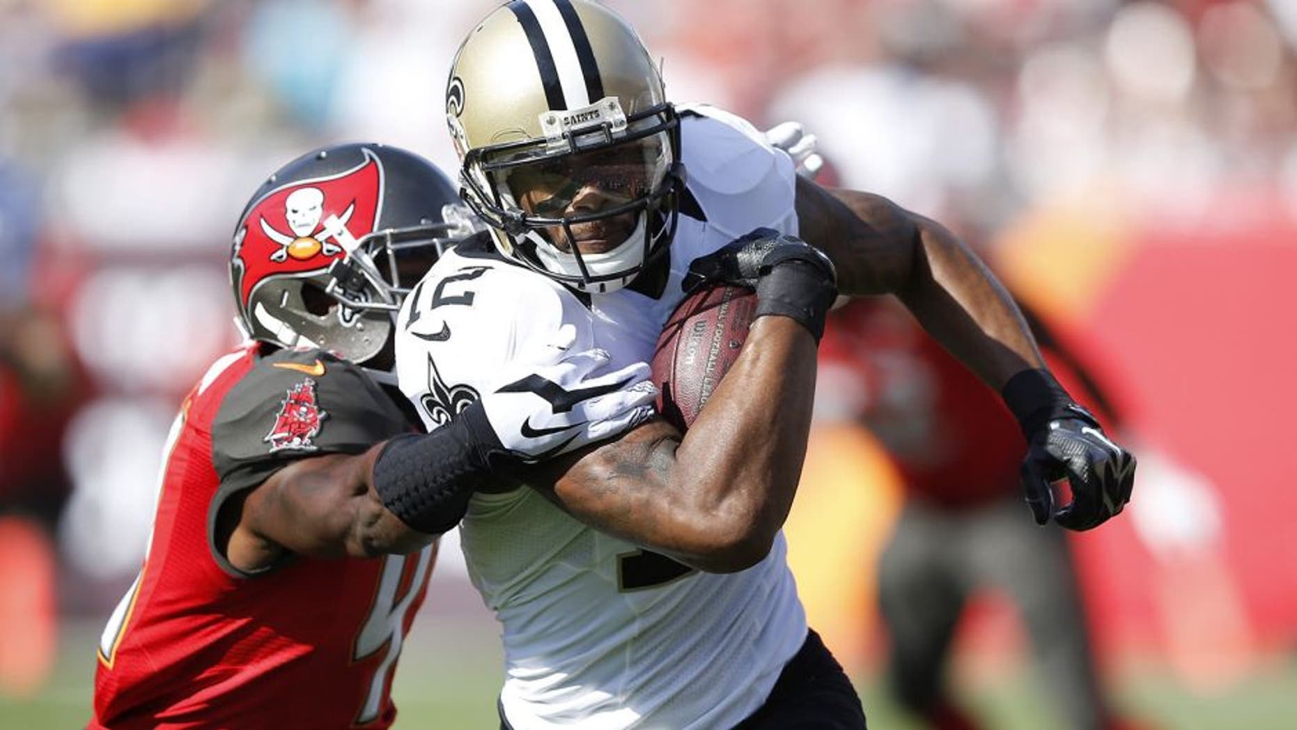 TAMPA, FL - DECEMBER 28: Marques Colston #12 of the New Orleans Saints runs upfield for extra yardage after a reception against the Tampa Bay Buccaneers during the first half of the game at Raymond James Stadium on December 28, 2014 in Tampa, Florida. (Photo by Joe Robbins/Getty Images)