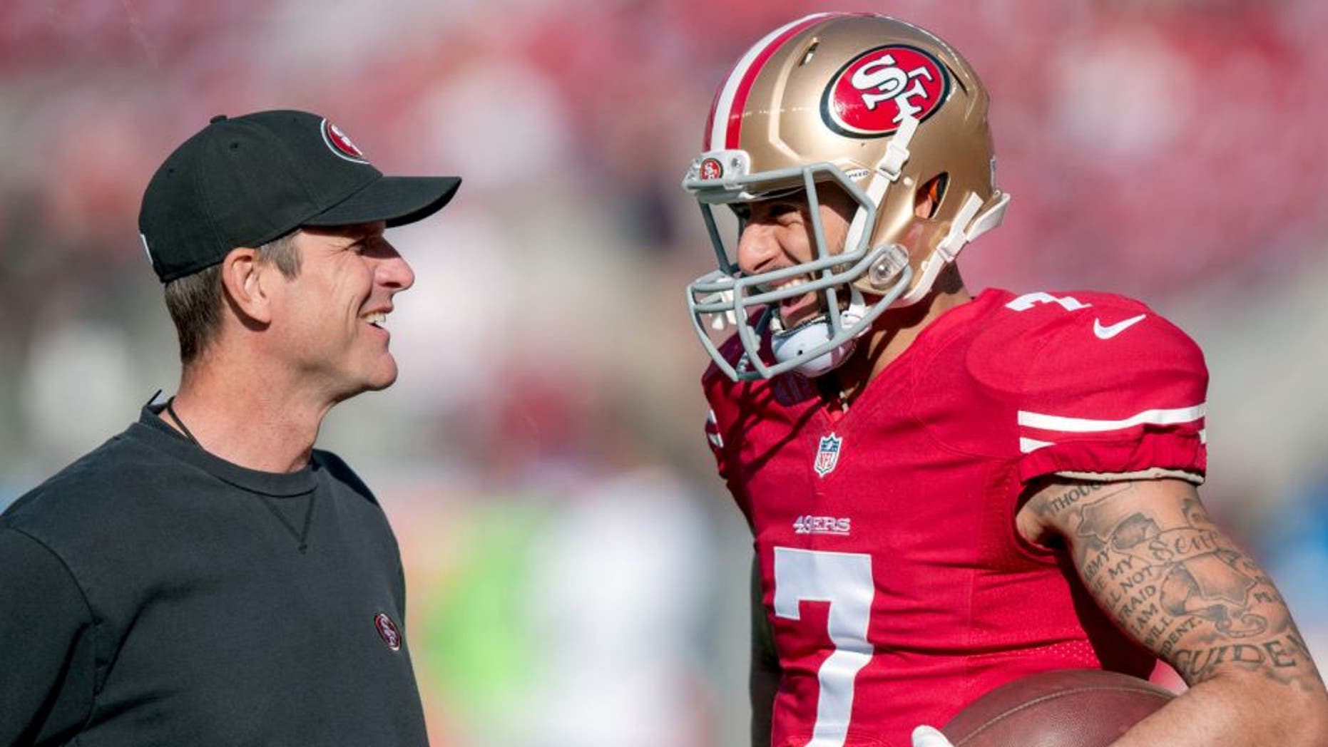 Dec 28, 2014; Santa Clara, CA, USA; San Francisco 49ers head coach Jim Harbaugh talks with quarterback Colin Kaepernick (7) during warmups before the game against the Arizona Cardinals at Levi's Stadium. The against the San Francisco 49ers defeated the Arizona Cardinals 20-17. Mandatory Credit: Ed Szczepanski-USA TODAY Sports