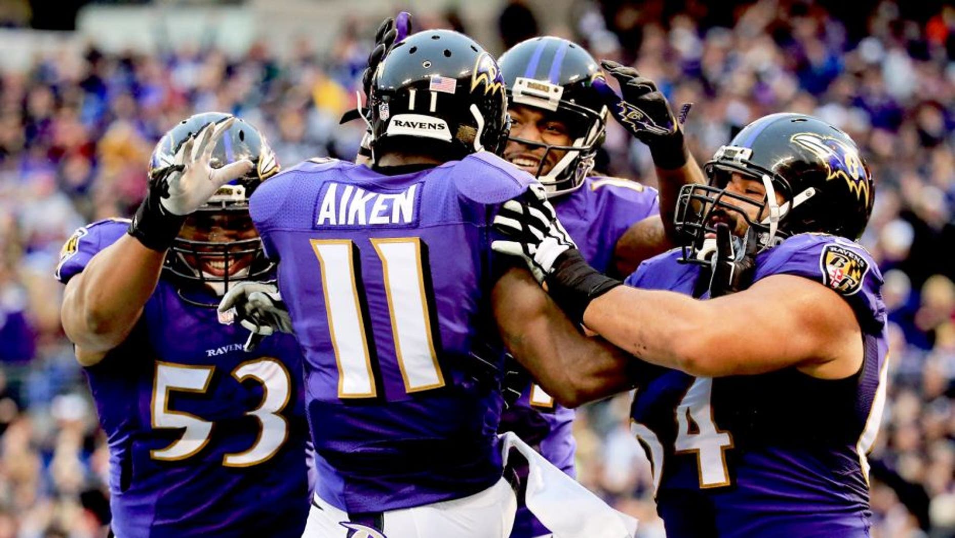 BALTIMORE, MD - DECEMBER 28: Wide receiver Kamar Aiken #11 of the Baltimore Ravens celebrates with teammates after catching a fourth quarter touchdown against the Cleveland Browns at M&T Bank Stadium on December 28, 2014 in Baltimore, Maryland. (Photo by Rob Carr/Getty Images)
