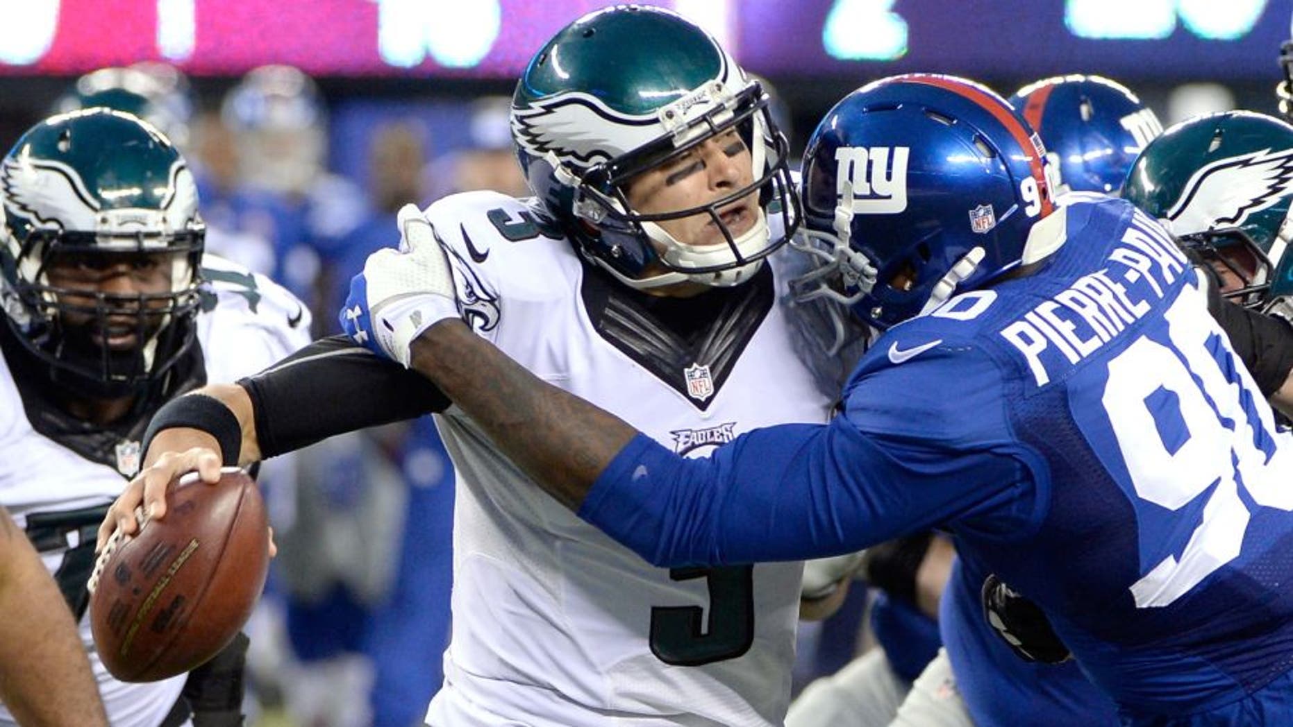 Dec 28, 2014; East Rutherford, NJ, USA; New York Giants defensive end Jason Pierre-Paul (90) sacks Philadelphia Eagles quarterback Mark Sanchez (3) in the second half during the game at MetLife Stadium. Mandatory Credit: Robert Deutsch-USA TODAY Sports
