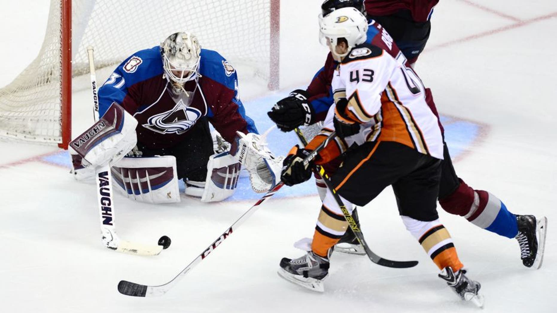 Sep 22, 2014; Denver, CO, USA; Colorado Avalanche goalie Calvin Pickard (31) makes a save on Anaheim Ducks left wing Max Friberg (43) as defenseman Chris Bigras (57) assists in defense in the second period at Pepsi Center. Mandatory Credit: Ron Chenoy-USA TODAY Sports