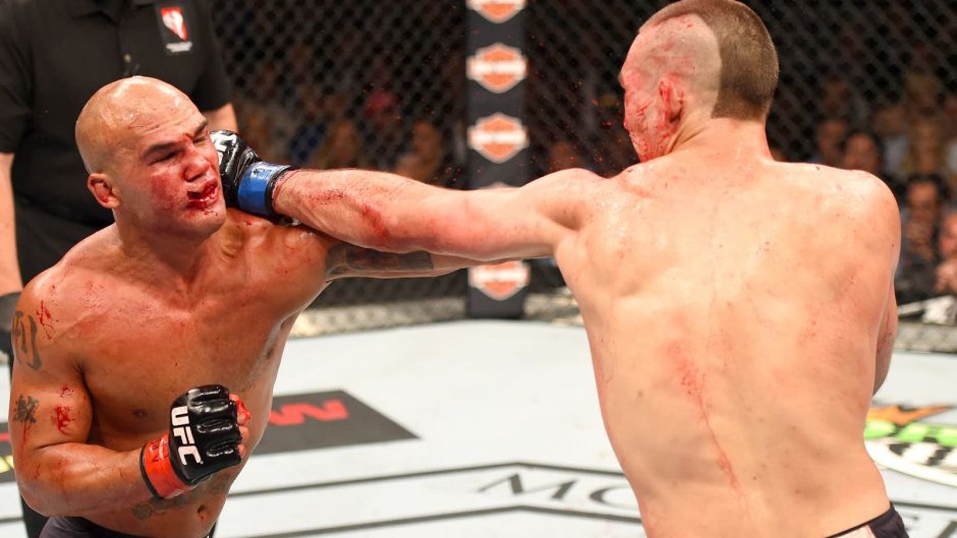LAS VEGAS, NV - JULY 11: (R-L) Rory MacDonald punches Robbie Lawler in their UFC welterweight title fight during the UFC 189 event inside MGM Grand Garden Arena on July 11, 2015 in Las Vegas, Nevada. (Photo by Josh Hedges/Zuffa LLC/Zuffa LLC via Getty Images)