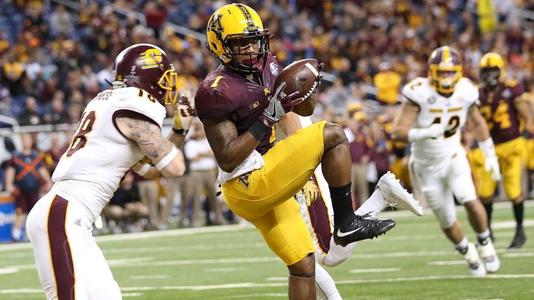DETROIT MI - DECEMBER 28: KJ Maye #1 of the Minnesota Golden Gophers makes the catch for a touchdown during the second quarter of the game over Tony Annese #18 of the Central Michigan Chippewas on December 28, 2015 during the Quick Lane Bowl at Ford Field in Detroit, Michigan. (Photo by Leon Halip/Getty Images)