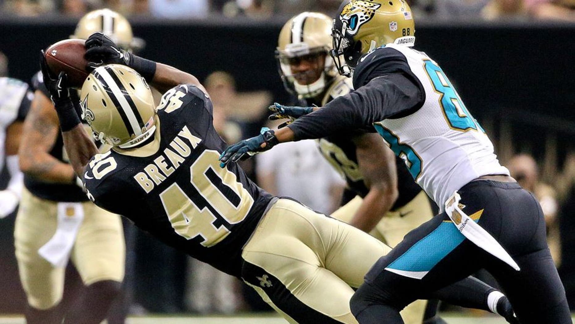 Dec 27, 2015; New Orleans, LA, USA; New Orleans Saints cornerback Delvin Breaux (40) intercepts a pass in front of Jacksonville Jaguars wide receiver Allen Hurns (88) during the second quarter of a game at the Mercedes-Benz Superdome. Mandatory Credit: Derick E. Hingle-USA TODAY Sports