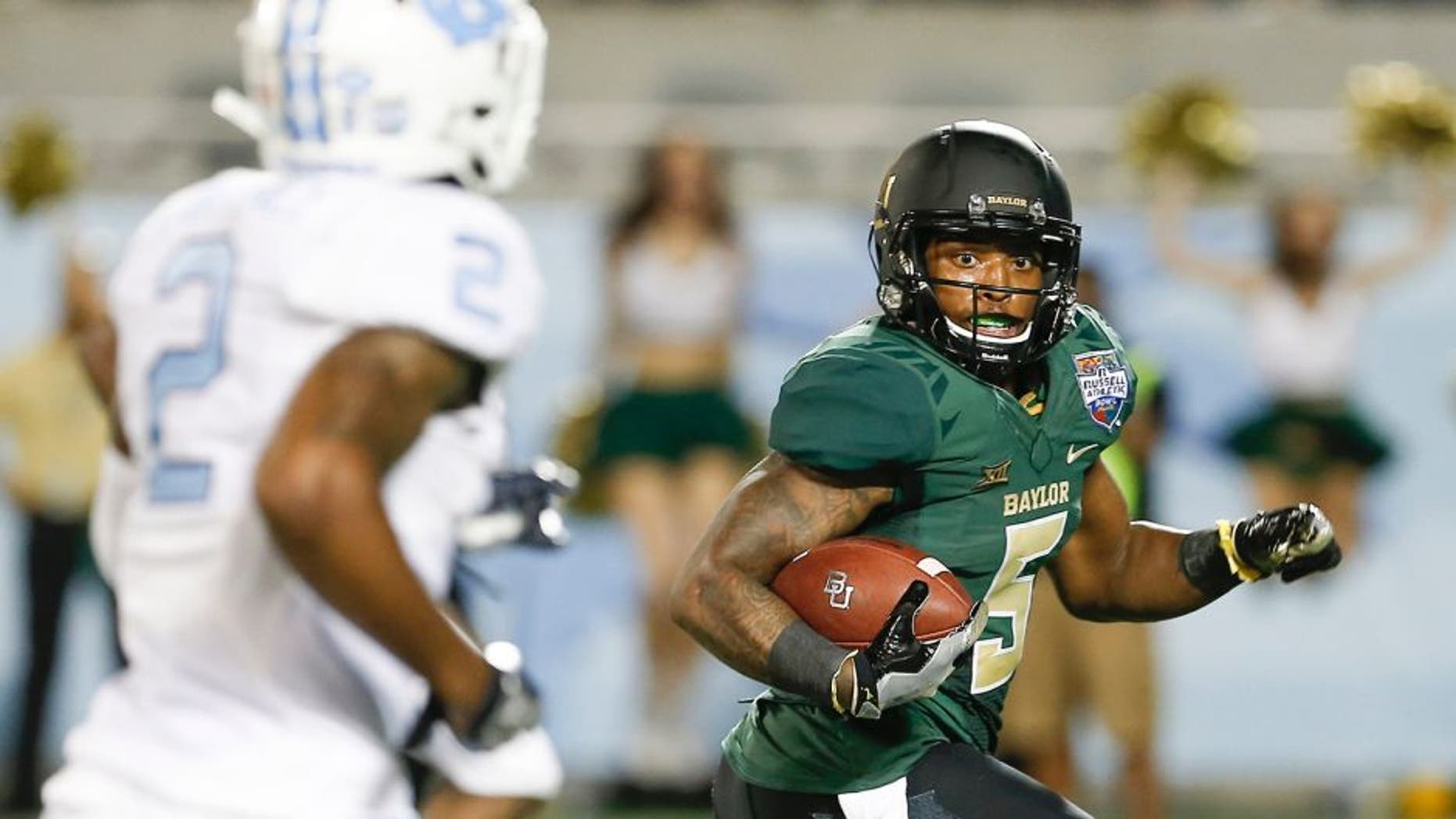 Dec 29, 2015; Orlando, FL, USA; Baylor Bears running back Johnny Jefferson (5) looks back at North Carolina Tar Heels cornerback Des Lawrence (2) before scoring on a touchdown run during the second quarter of a football game at Florida Citrus Bowl. Mandatory Credit: Reinhold Matay-USA TODAY Sports