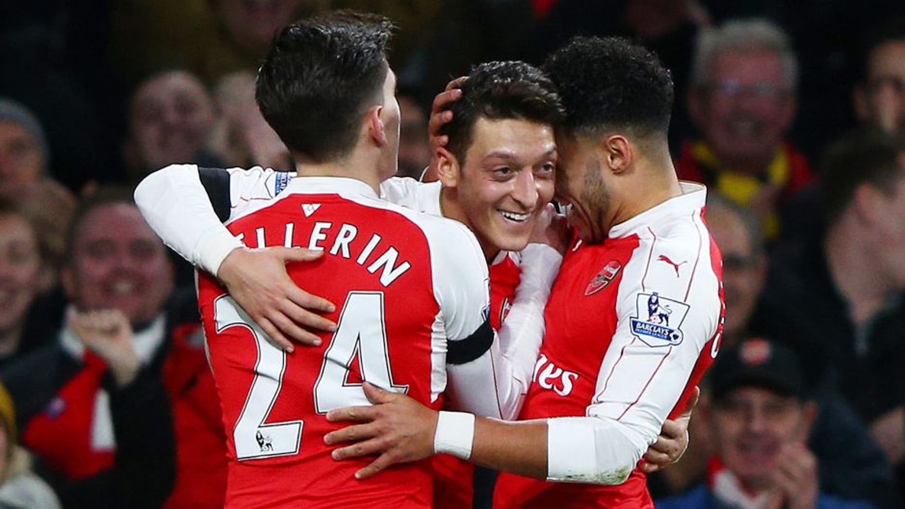 LONDON, ENGLAND - DECEMBER 28: Mesut Ozil (C) of Arsenal celebrates scoring his team's second goal with his team mates Alex Oxlade-Chamberlain (R) and Hector Bellerin (L) during the Barclays Premier League match between Arsenal and A.F.C. Bournemouth at Emirates Stadium on December 28, 2015 in London, England. (Photo by Ian Walton/Getty Images)
