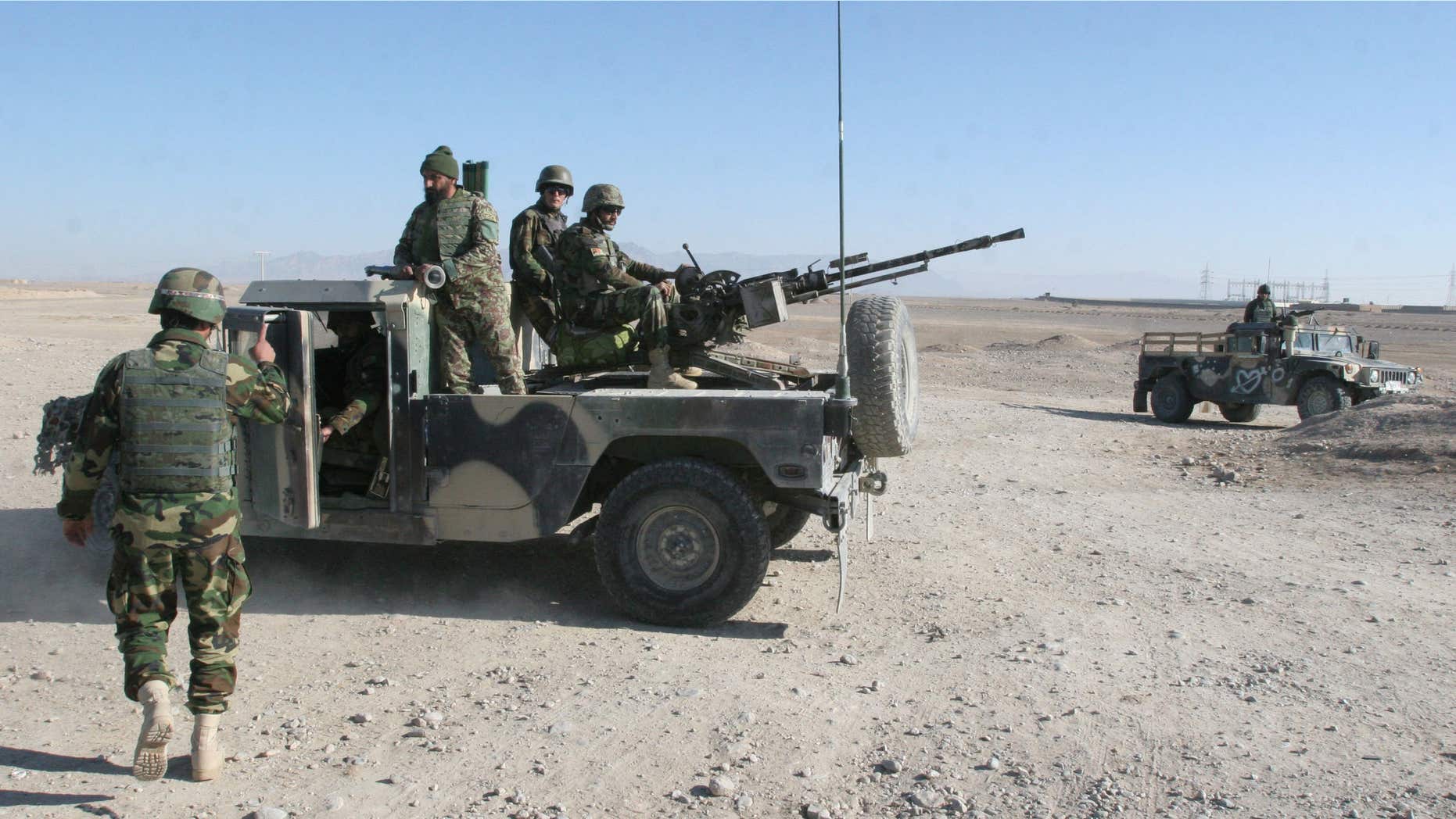 Dec. 23, 2015: Afghan National Army soldiers guard at a checkpoint on the way to the Sangin district of Helmand province, Afghanistan