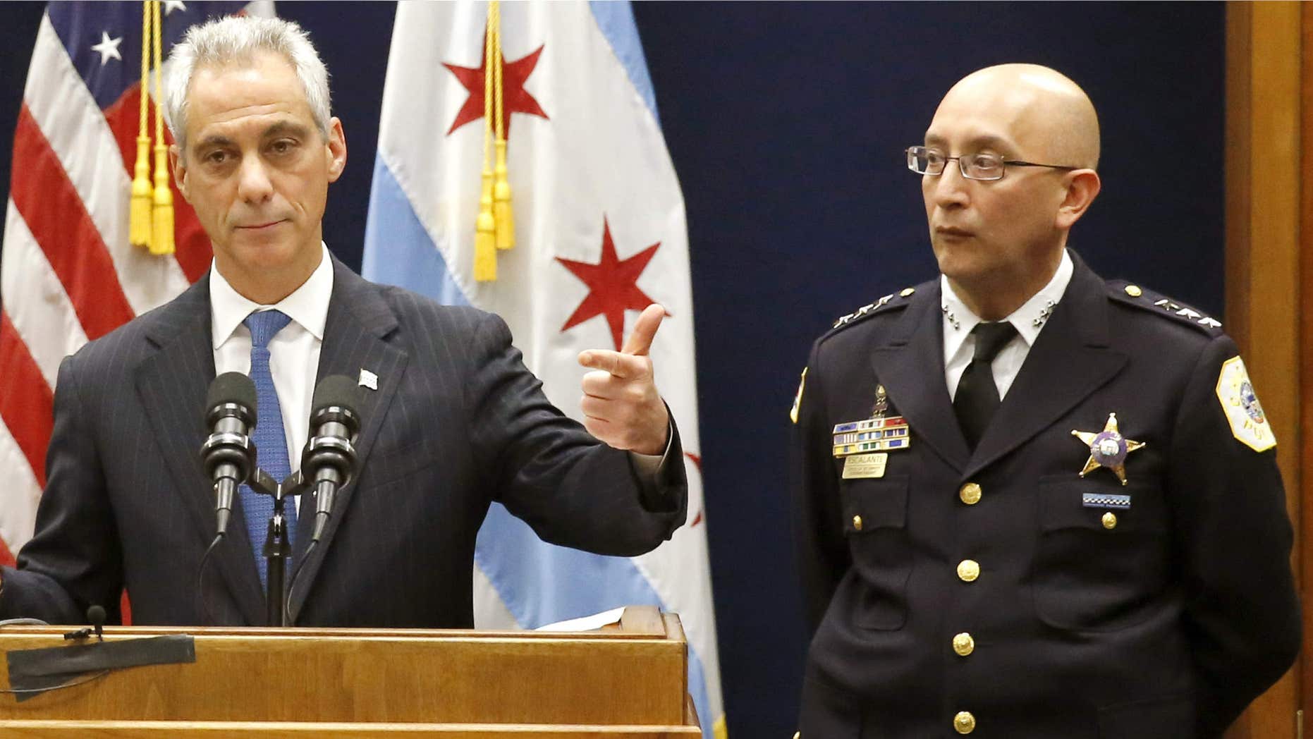 FILE - In this Dec. 7, 2015 file photo, Chicago Mayor Rahm Emanuel, accompanied by Interim Chicago Police Superintendent John Escalante, speaks during a news conference in Chicago.