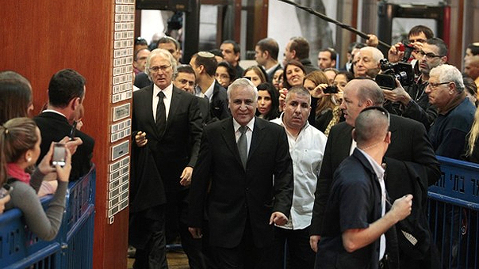 Dec. 30: Israel's former president Moshe Katsav (C) arrives at Tel Aviv District Court to hear the verdict on charges of rape and sexual misconduct against him.