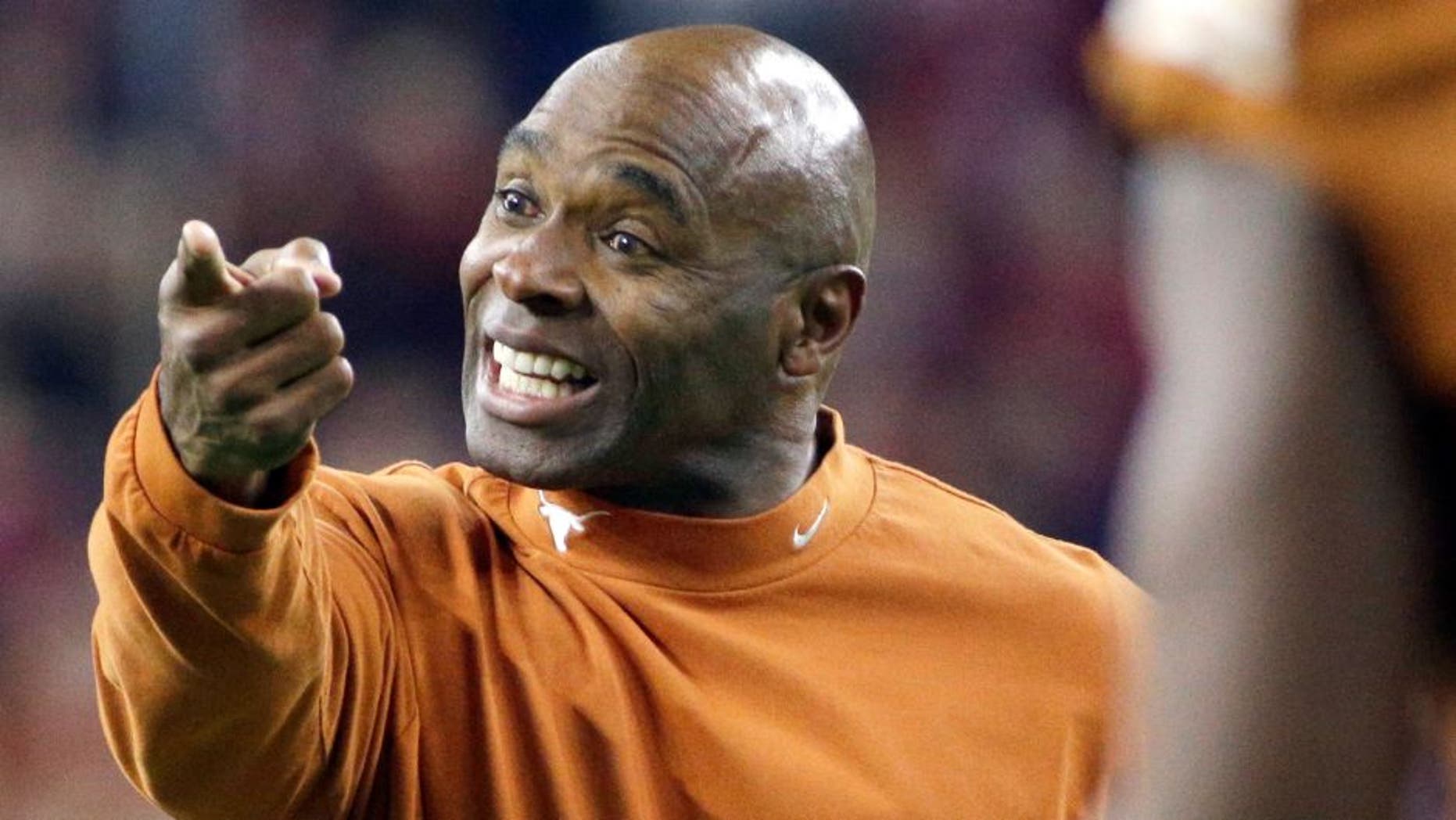 Texas head coach Charlie Strong yells to his players during the first half of the Texas Bowl NCAA college football game against Arkansas Monday, Dec. 29, 2014, in Houston. (AP Photo/David J. Phillip)