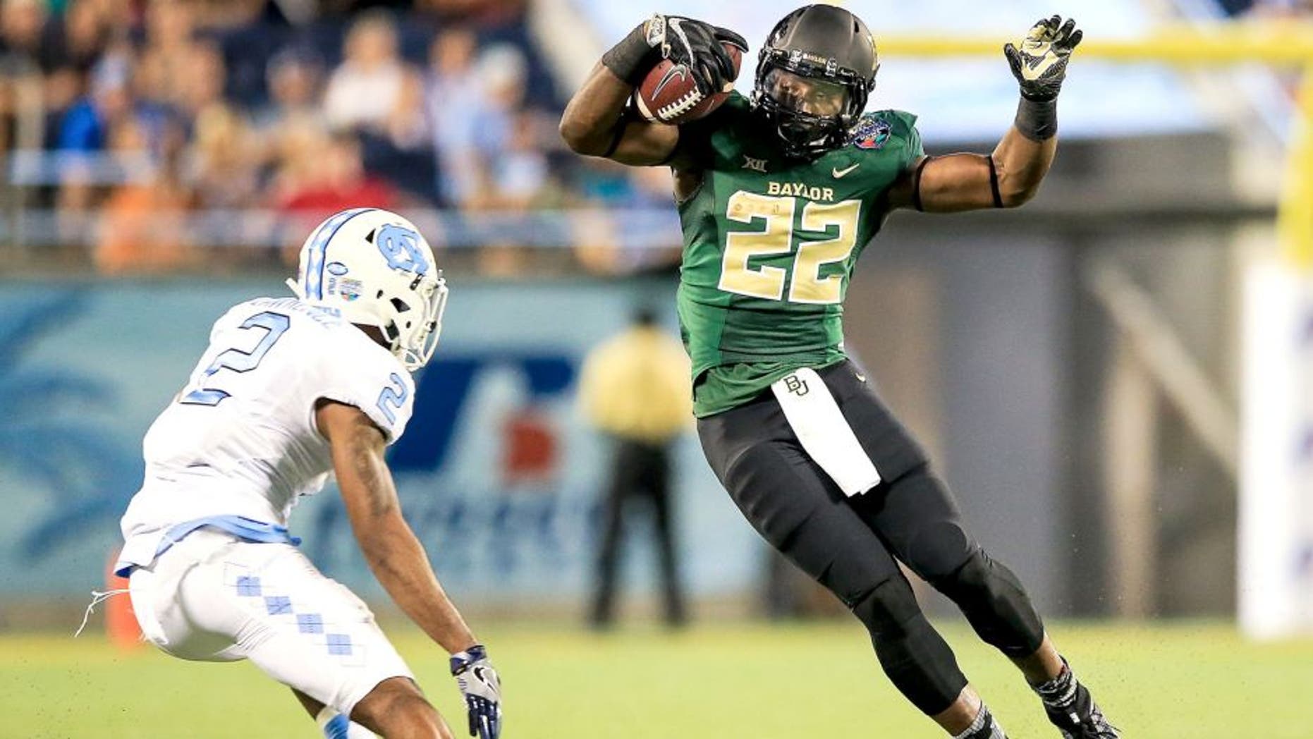 ORLANDO, FL - DECEMBER 29: Terence Williams #22 of the Baylor Bears is defended by Des Lawrence #2 of the North Carolina Tar Heels of the Russell Athletic Bowl game at Orlando Citrus Bowl on December 29, 2015 in Orlando, Florida. (Photo by Rob Foldy/Getty Images)