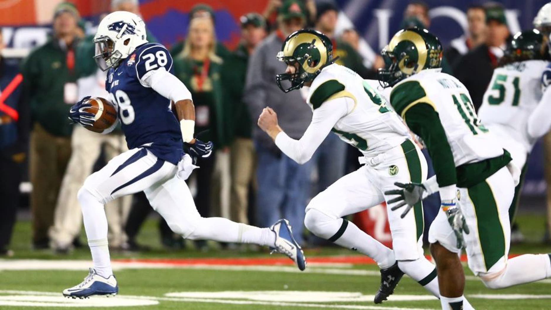 Dec 29, 2015; Tucson, AZ, USA; Nevada Wolf Pack kick returner Elijah Mitchell (28) returns a kickoff for a touchdown against the Colorado State Rams in the second quarter of the Arizona Bowl at Arizona Stadium. Mandatory Credit: Mark J. Rebilas-USA TODAY Sports