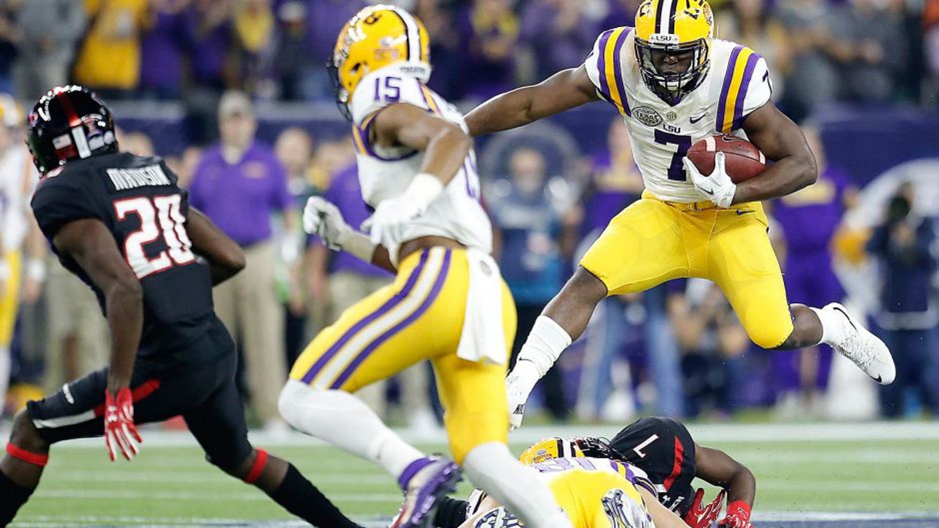 Dec 29, 2015; Houston, TX, USA; LSU Tigers running back Leonard Fournette (7) rushes against the Texas Tech Red Raiders in the first quarter at NRG Stadium. Mandatory Credit: Thomas B. Shea-USA TODAY Sports