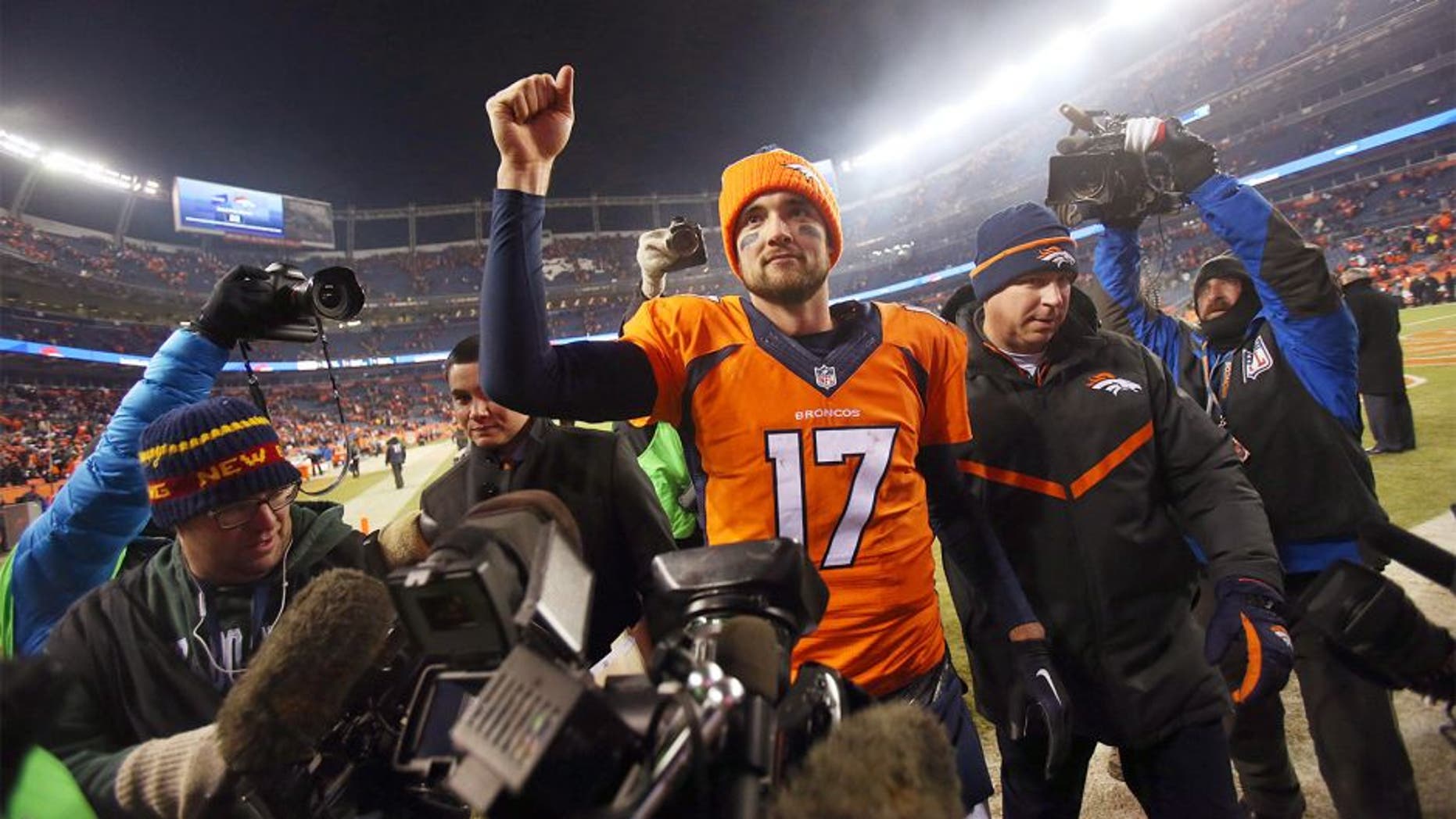 Dec 28, 2015; Denver, CO, USA; Denver Broncos quarterback Brock Osweiler (17) celebrates after the game against the Cincinnati Bengals at Sports Authority Field at Mile High. The Broncos won 20-17 in overtime. Mandatory Credit: Chris Humphreys-USA TODAY Sports
