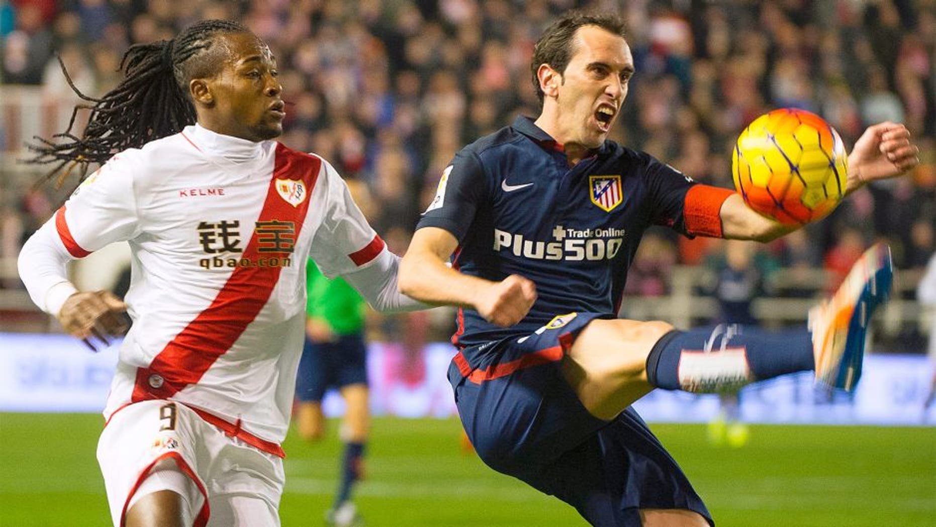Rayo Vallecano's Angolan forward Alberto Manucho (L) vies with Atletico Madrid's Uruguayan defender Diego Godin during the Spanish league football match Rayo Vallecano de Madrid vs Club Atletico de Madrid at Vallecas stadium in Madrid on December 30, 2015. AFP PHOTO/ CURTO DE LA TORRE / AFP / CURTO DE LA TORRE (Photo credit should read CURTO DE LA TORRE/AFP/Getty Images)