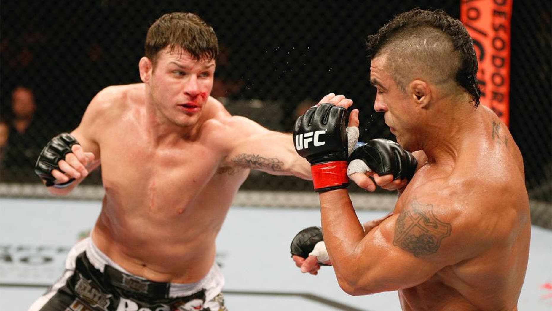 SAO PAULO, BRAZIL - JANUARY 19: (L-R) Michael Bisping punches Vitor Belfort in their middleweight fight at the UFC on FX event on January 19, 2013 at Ibirapuera Gymnasium in Sao Paulo, Brazil. (Photo by Josh Hedges/Zuffa LLC/Zuffa LLC via Getty Images)