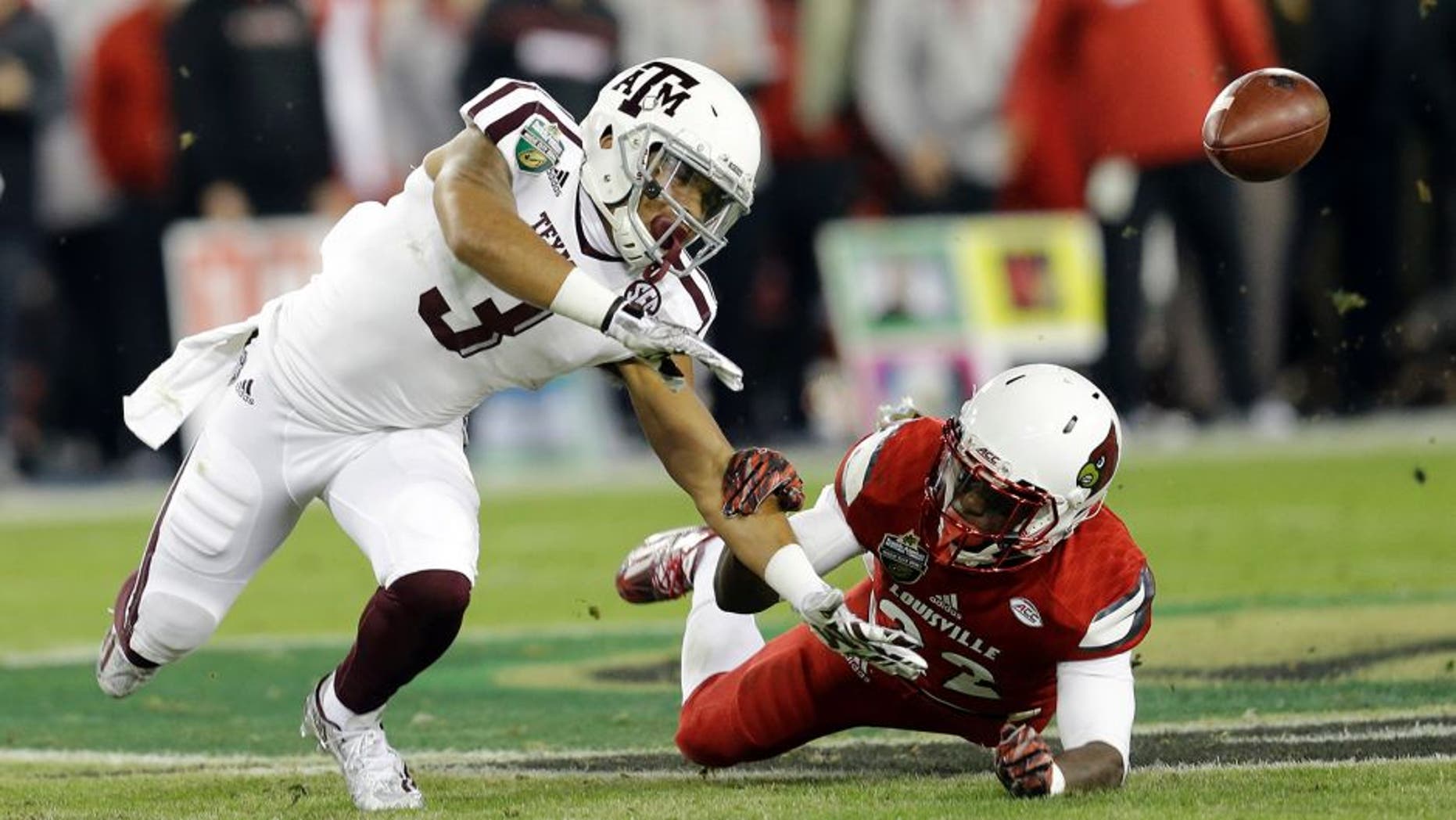 Louisville safety Chucky Williams, right, breaks up a pass intended for Texas A&M wide receiver Christian Kirk (3) in the first half of the Music City Bowl NCAA college football game Wednesday, Dec. 30, 2015, in Nashville, Tenn. (AP Photo/Mark Humphrey)