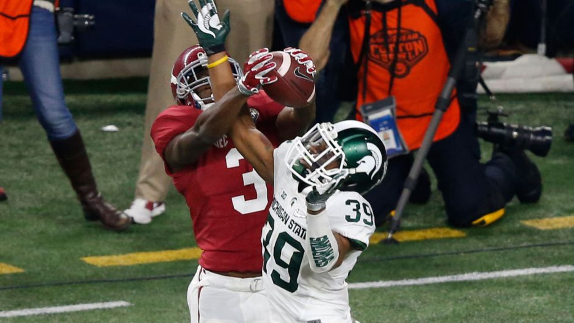 Dec 31, 2015; Arlington, TX, USA; Alabama Crimson Tide wide receiver Calvin Ridley (3) is tackled by Michigan State Spartans cornerback Darian Hicks (2) in the first quarter in the 2015 CFP semifinal at the Cotton Bowl at AT&T Stadium. Mandatory Credit: Matthew Emmons-USA TODAY Sports