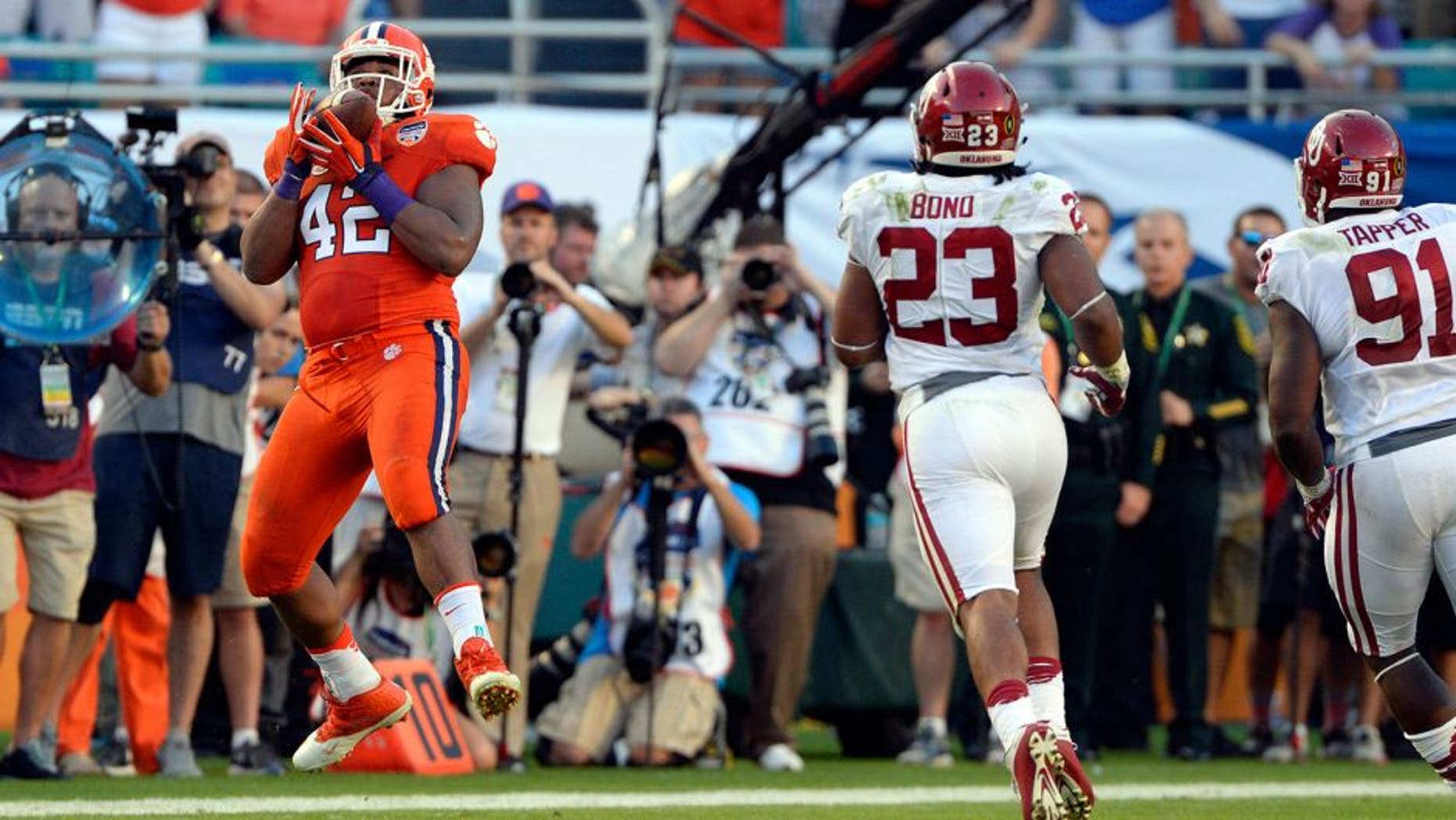Dec 31, 2015; Miami Gardens, FL, USA; Clemson Tigers defensive lineman Christian Wilkins (42) catches a pass on a fake punt against the Oklahoma Sooners during the first half of the 2015 CFP semifinal at the Orange Bowl at Sun Life Stadium. Mandatory Credit: Tommy Gilligan-USA TODAY Sports
