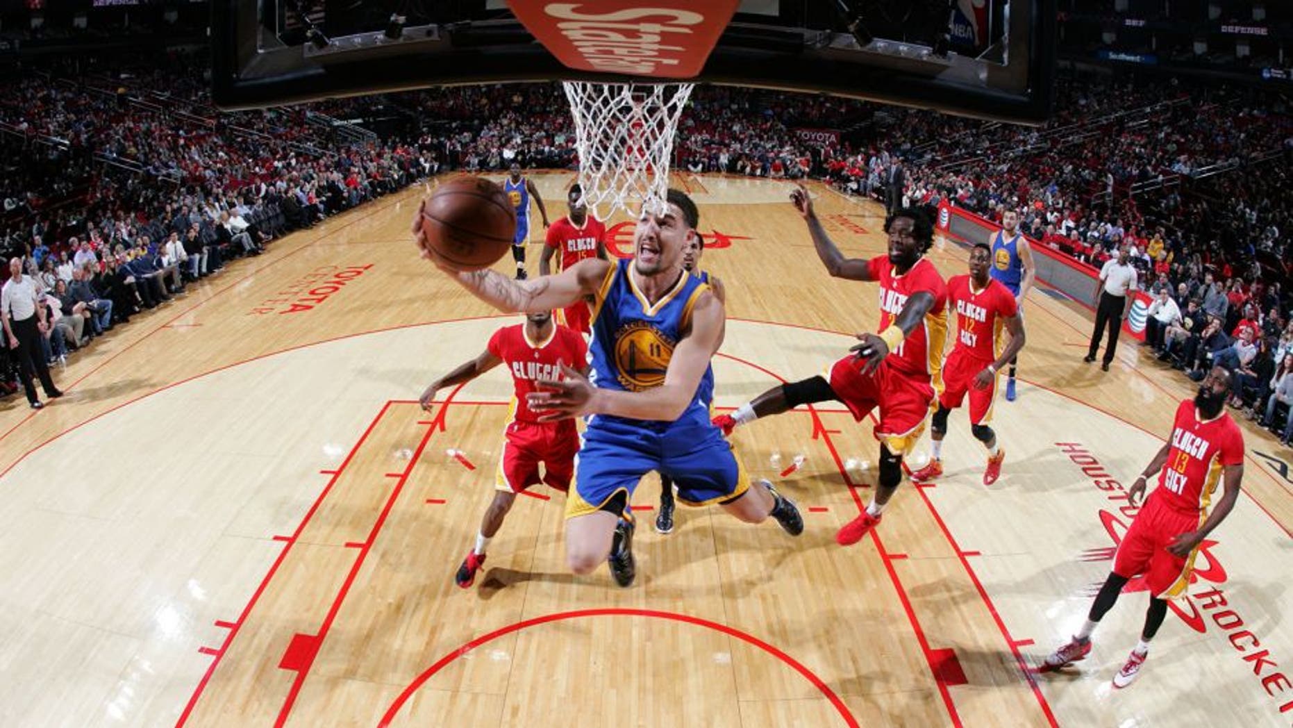 HOUSTON, TX - DECEMBER 31: Klay Thompson #11 of the Golden State Warriors goes to the basket against the Houston Rockets on December 31, 2015 at the Toyota Center in Houston, Texas. NOTE TO USER: User expressly acknowledges and agrees that, by downloading and or using this photograph, User is consenting to the terms and conditions of the Getty Images License Agreement. Mandatory Copyright Notice: Copyright 2015 NBAE (Photo by Bill Baptist/NBAE via Getty Images)