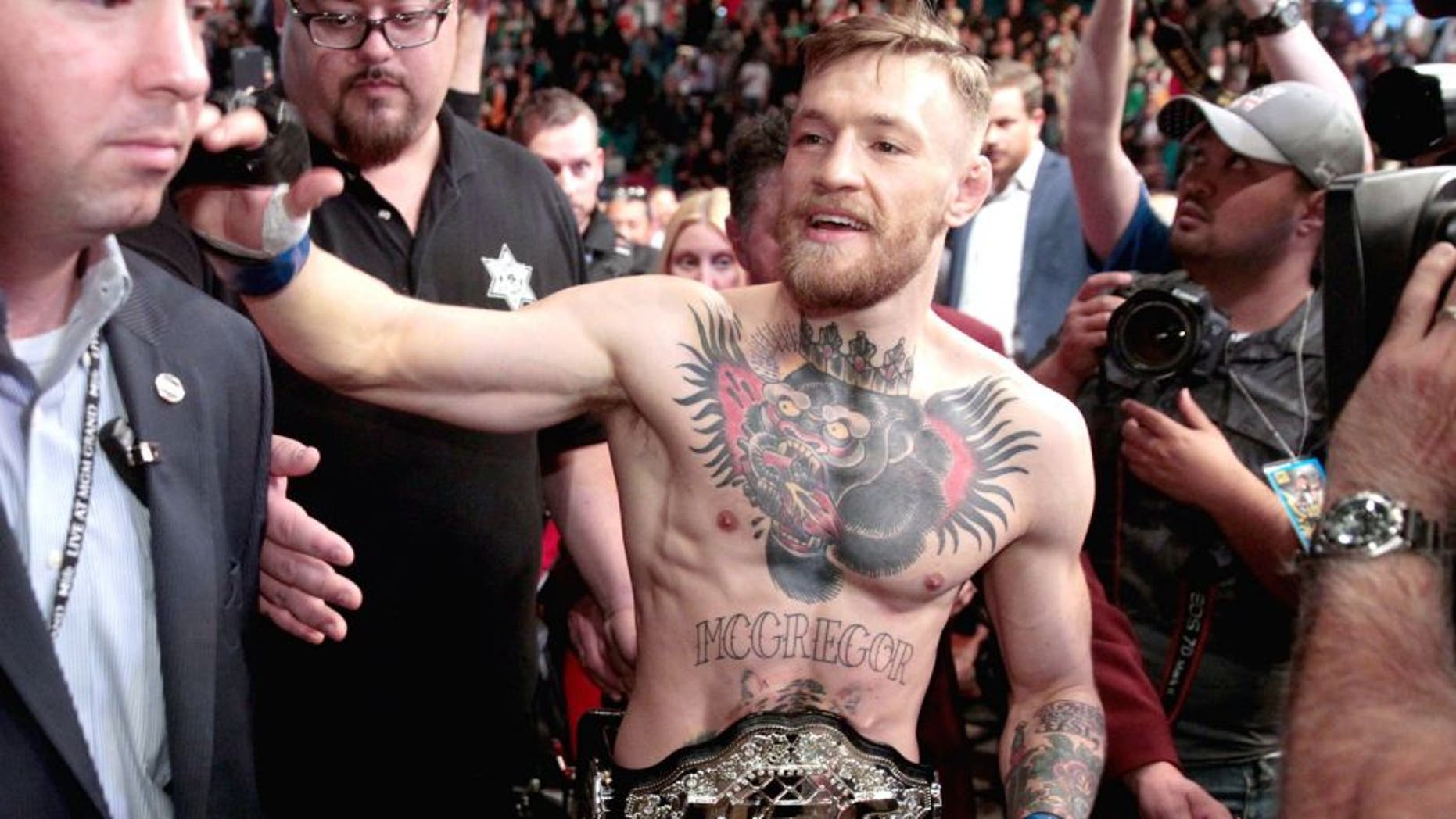 LAS VEGAS, NV - DECEMBER 12: Conor McGregor leaves the Octagon after his first-round knockout victory over Jose Aldo in their featherweight title fight during UFC 194 on December 12, 2015 in Las Vegas, Nevada. (Photo by Steve Marcus/Getty Images)